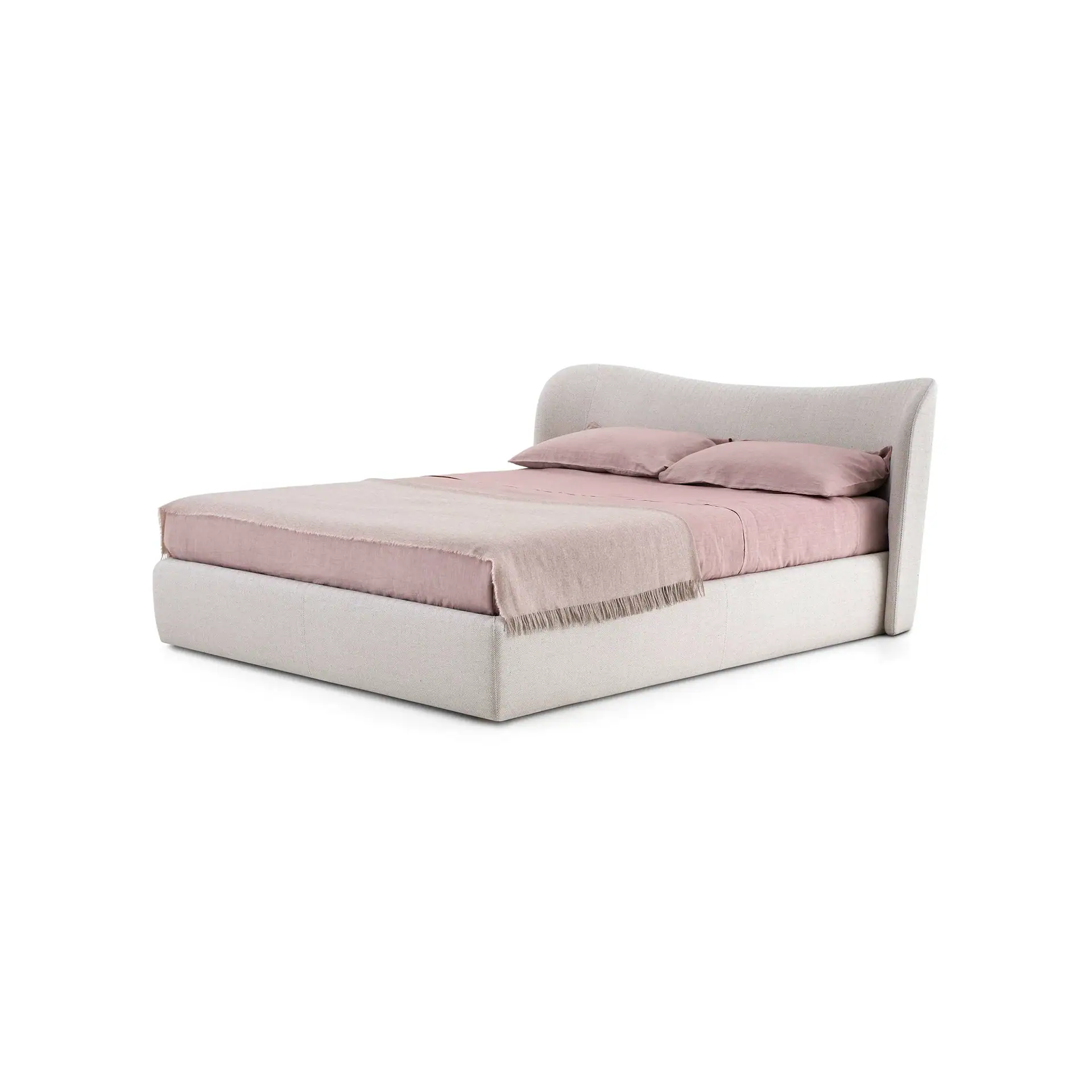 An upholstered bed with a curved headboard, pink bedding, and a fringed throw blanket on a white background.