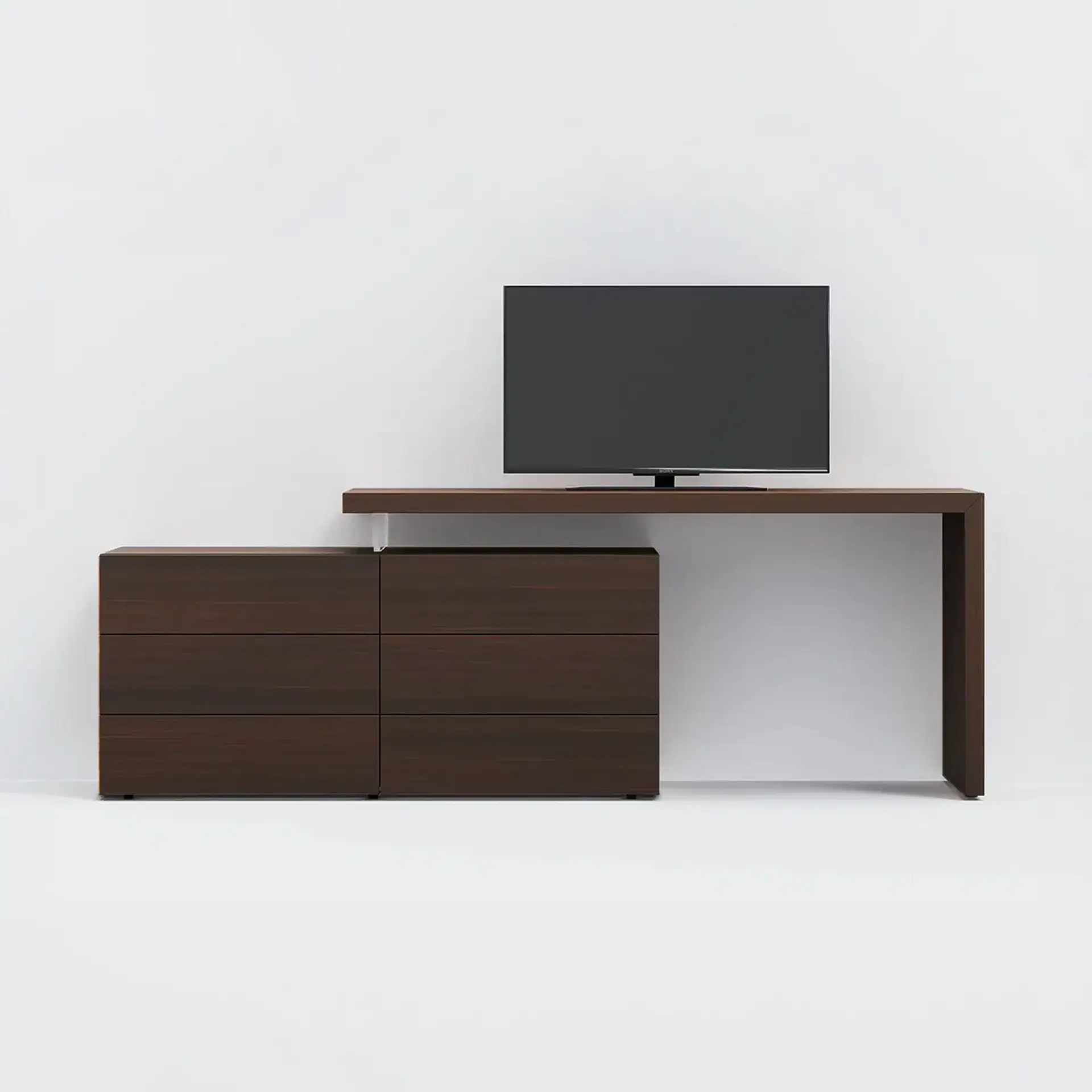 A dark brown modern media console with six drawers and an L-shaped desk extension, featuring a flat-screen TV on top, against a light gray background.