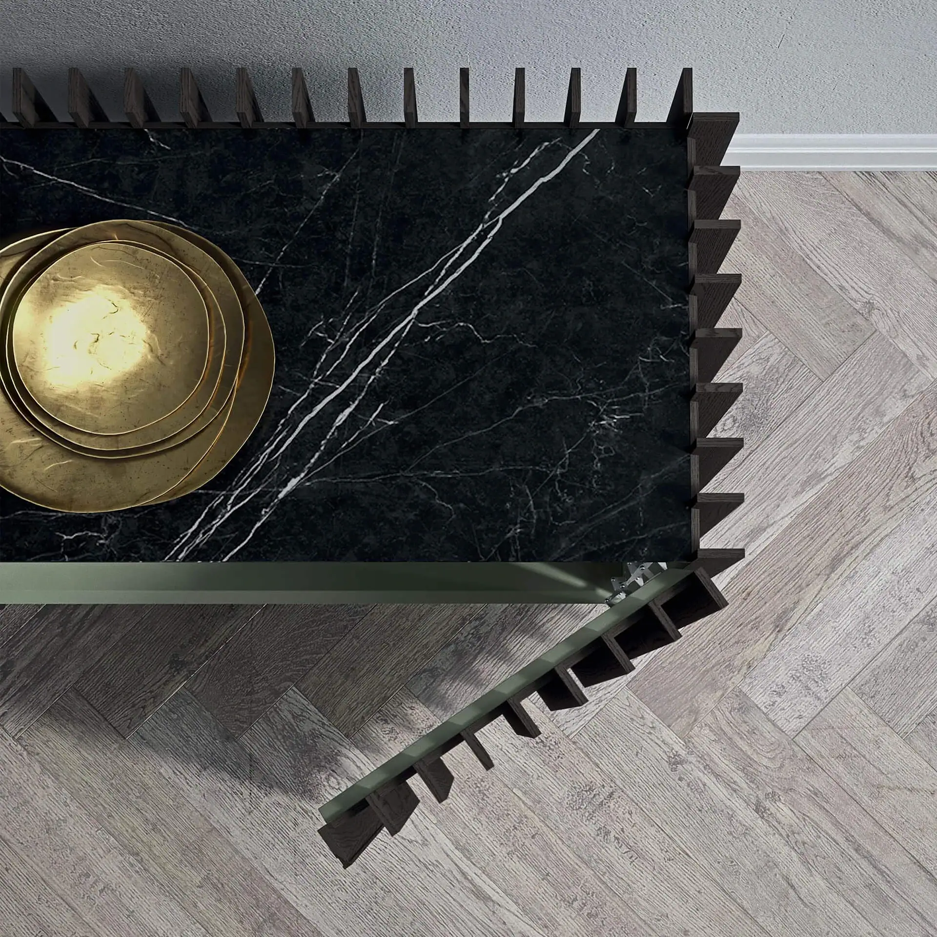 Overhead view of a modern console table with a dark marble top, white veins, and golden plates. It has dark wooden sawtooth edges and stands on a light herringbone wood floor next to a gray wall.