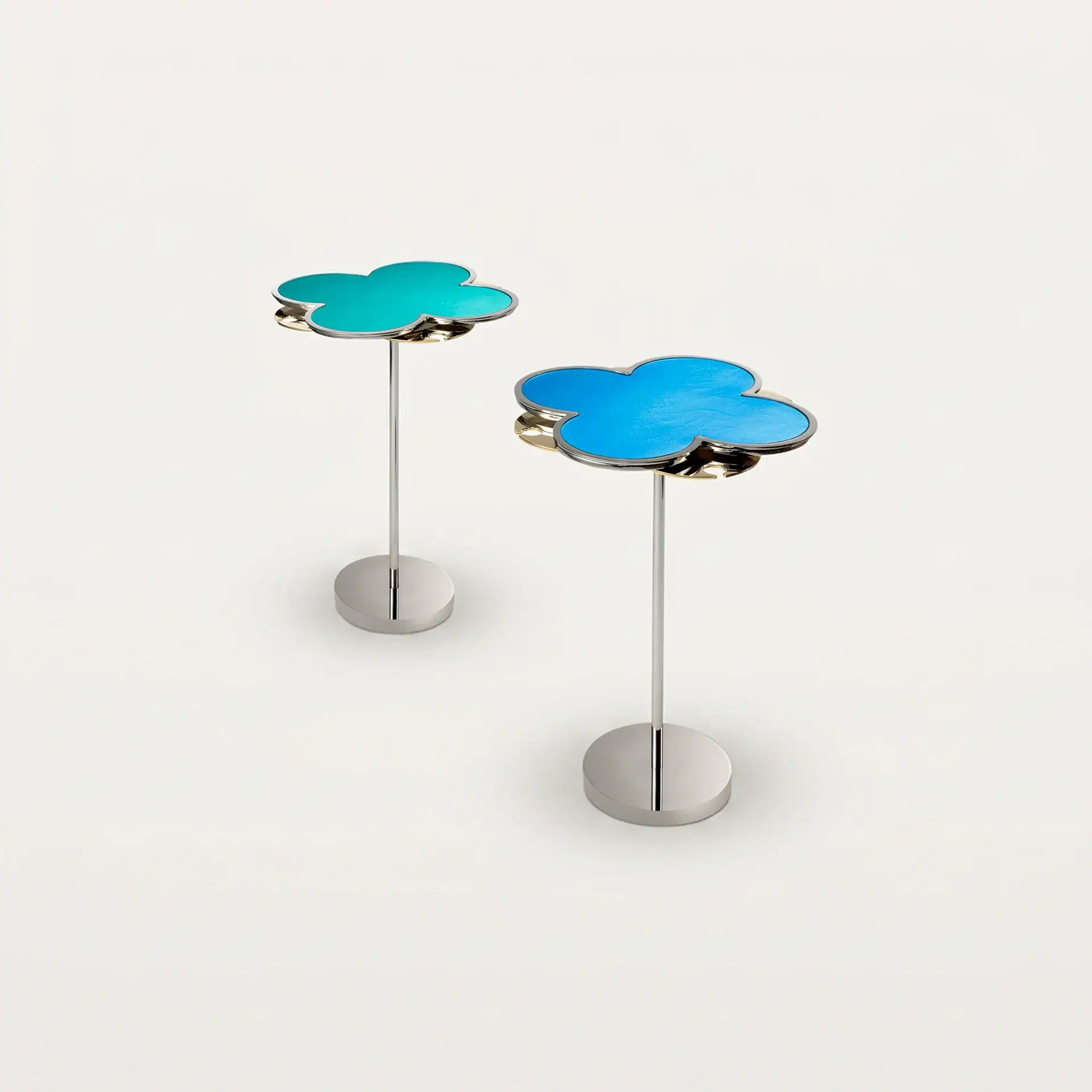 Two cloud-shaped decorative items on stands, one teal and one blue, against a light gray background.