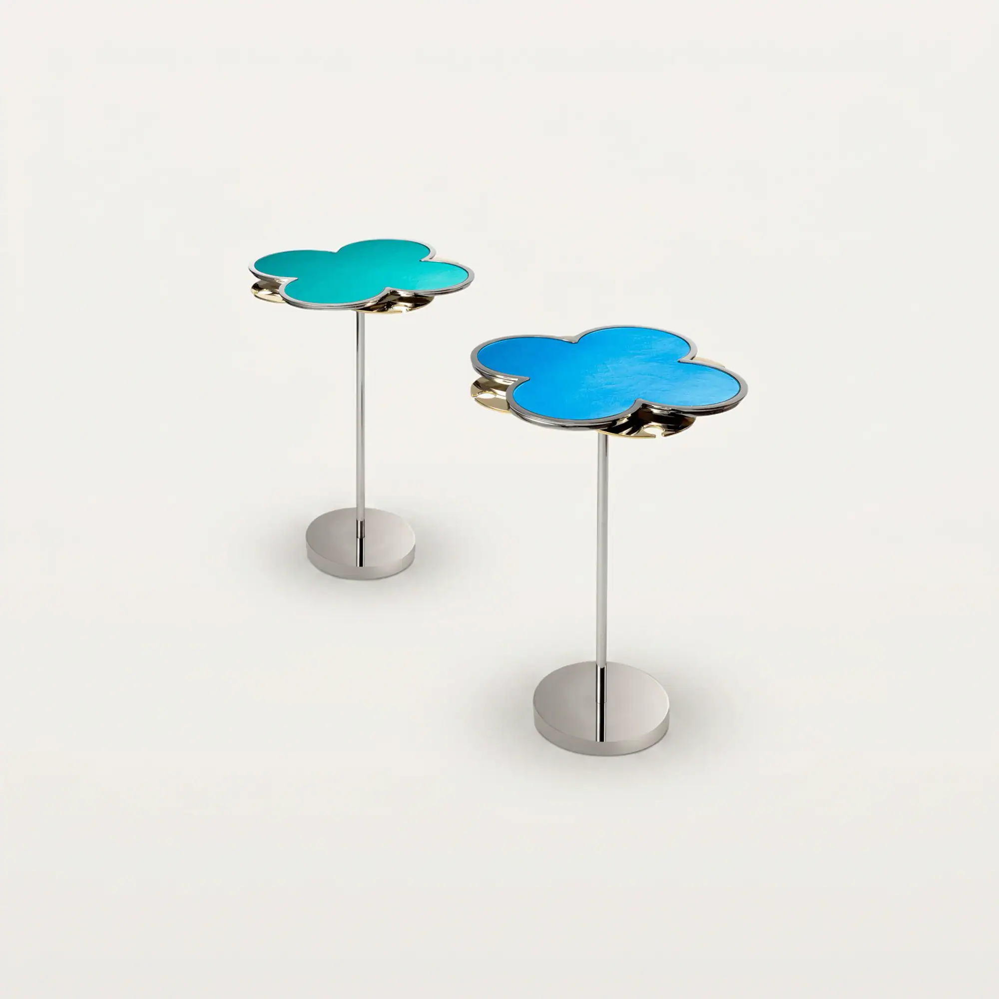 Two cloud-shaped decorative items on stands, one teal and one blue, against a light gray background.
