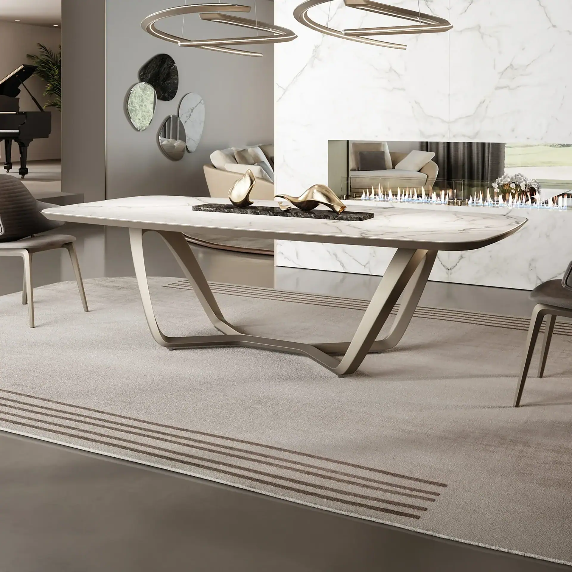 A modern dining room with a large marble-topped table, sculptural bronze base, and gray chairs on a striped rug. A linear fireplace is in the background, and a grand piano is visible in an adjacent room.