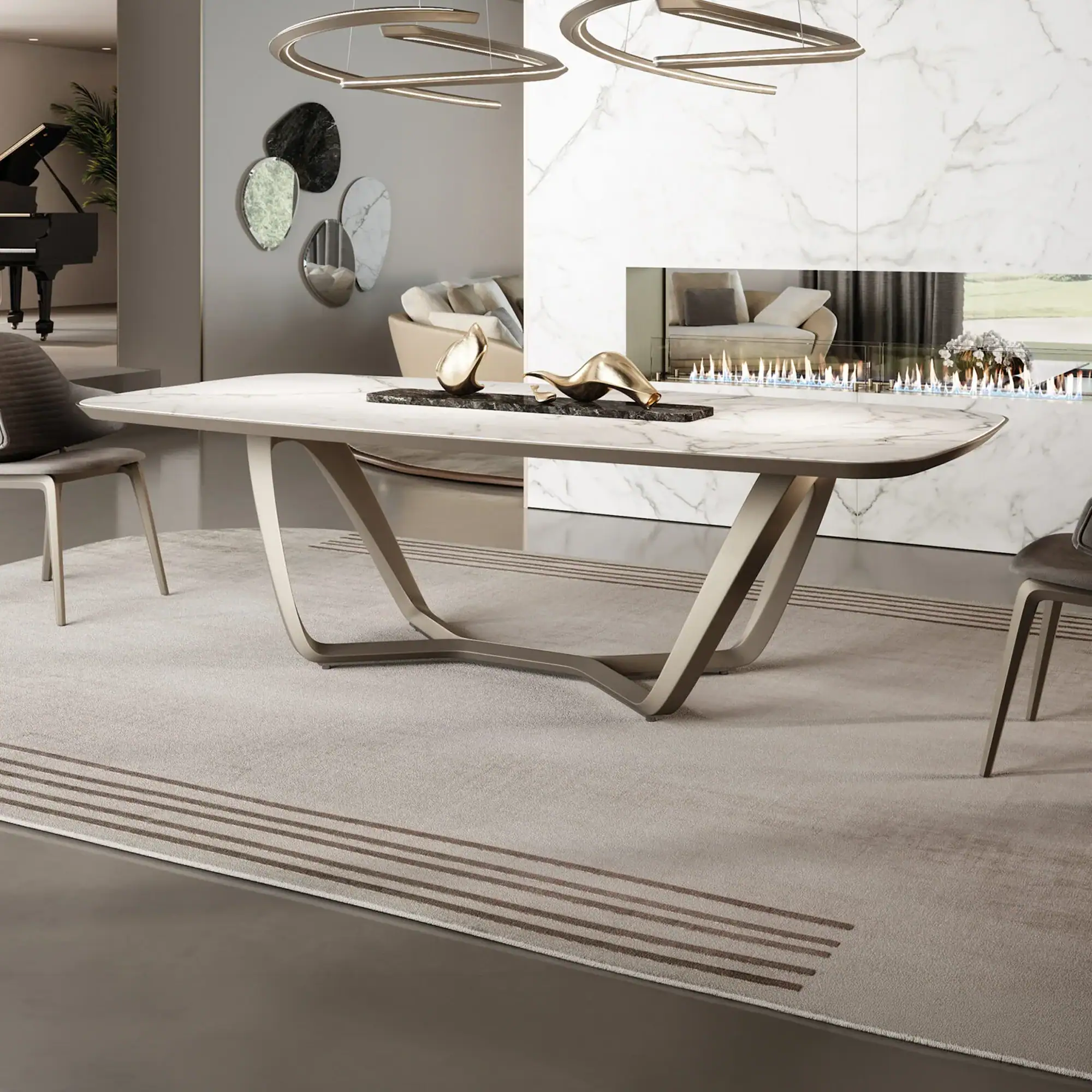 A modern dining room with a large marble-topped table, sculptural bronze base, and gray chairs on a striped rug. A linear fireplace is in the background, and a grand piano is visible in an adjacent room.