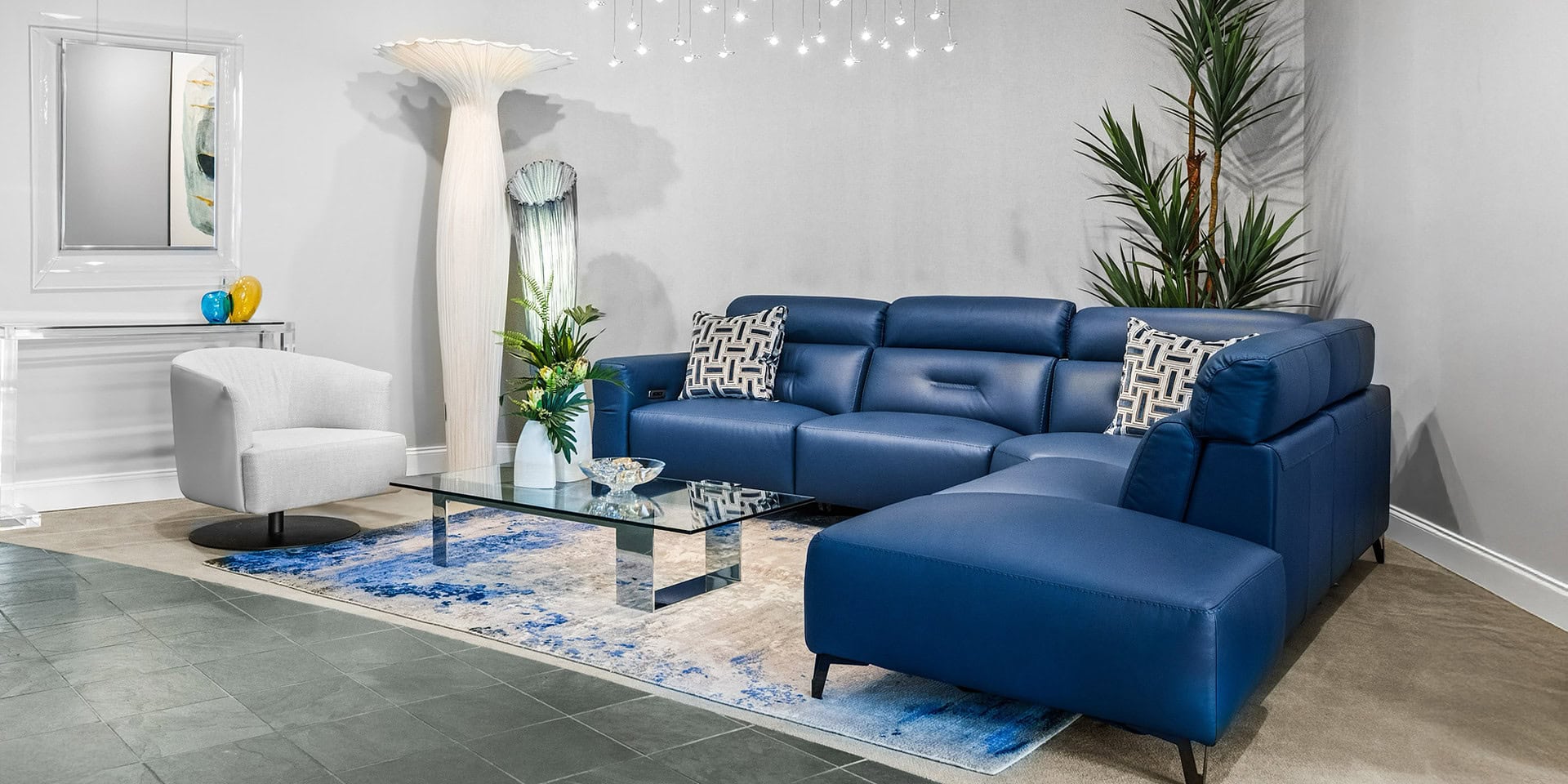 Stylish blue sectional sofa with matching ottoman in contemporary living space.