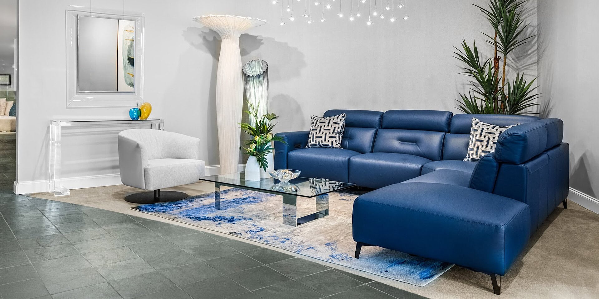 Stylish blue sectional sofa with matching ottoman in contemporary living space.