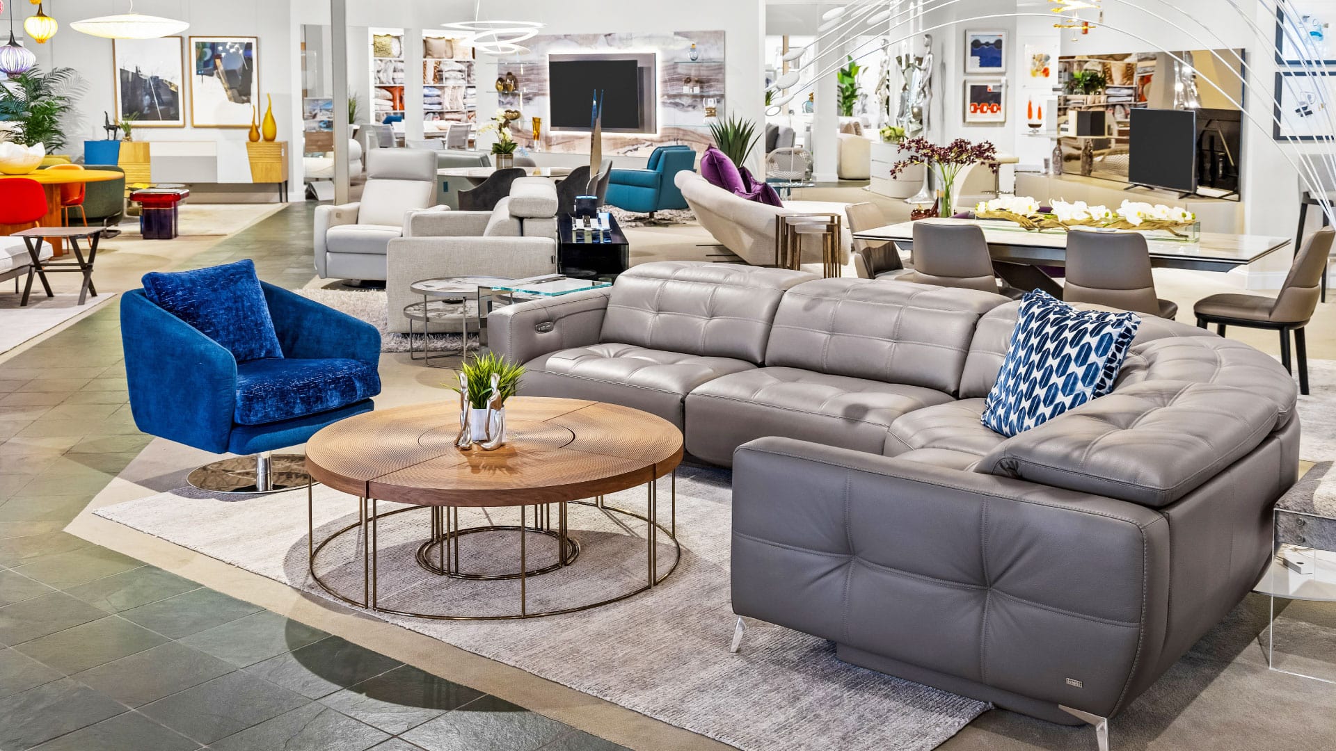 Elegant sectional sofa with accent chairs and contemporary decor.