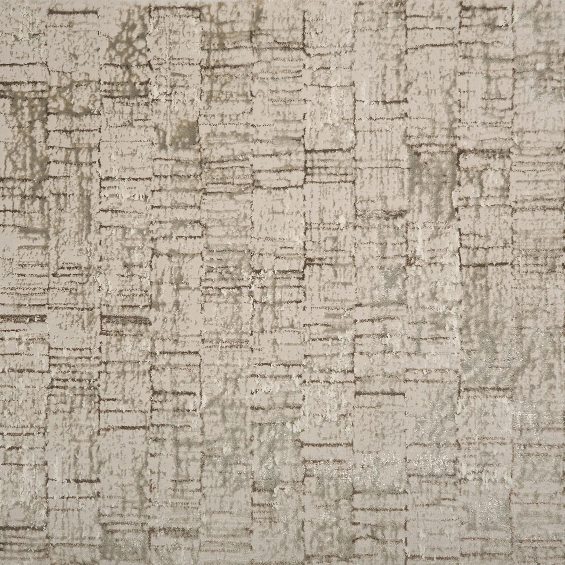 Close-up of a beige textured rug with an abstract pattern of distressed brown and gray lines forming irregular blocks.
