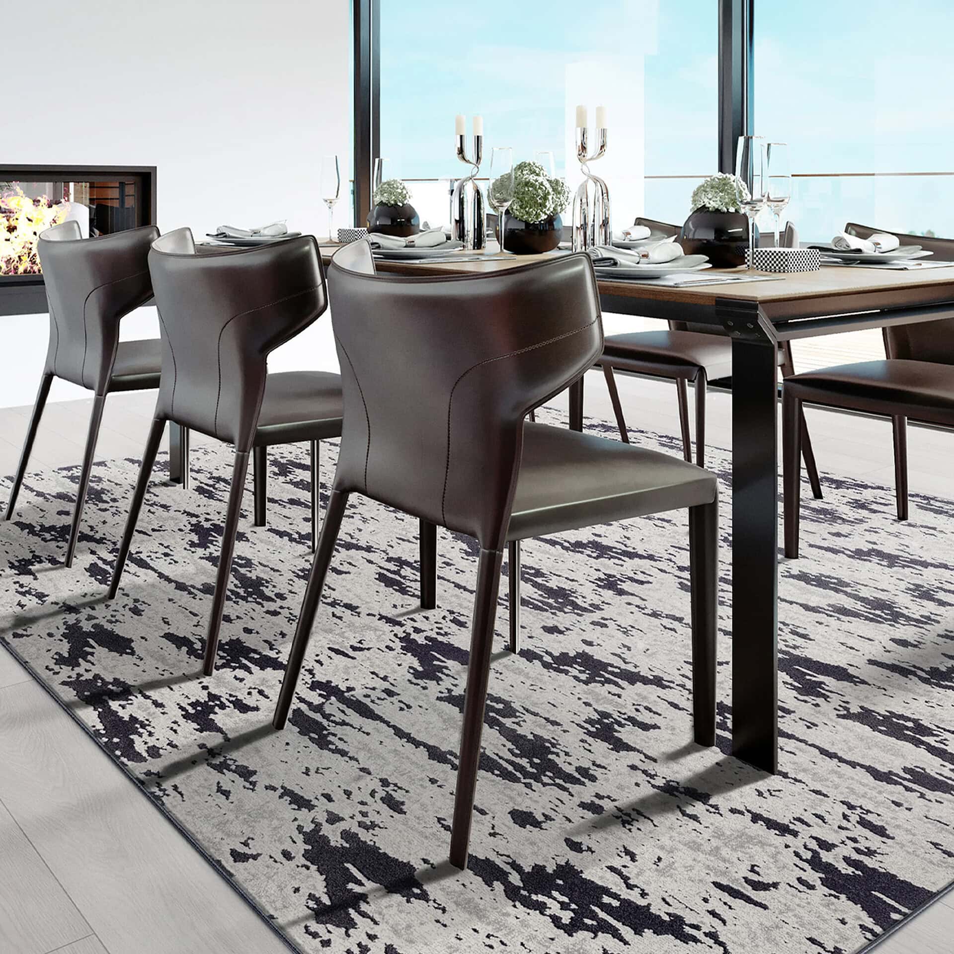 Modern dining room with Arabella patterned area rug and sleek black chairs.