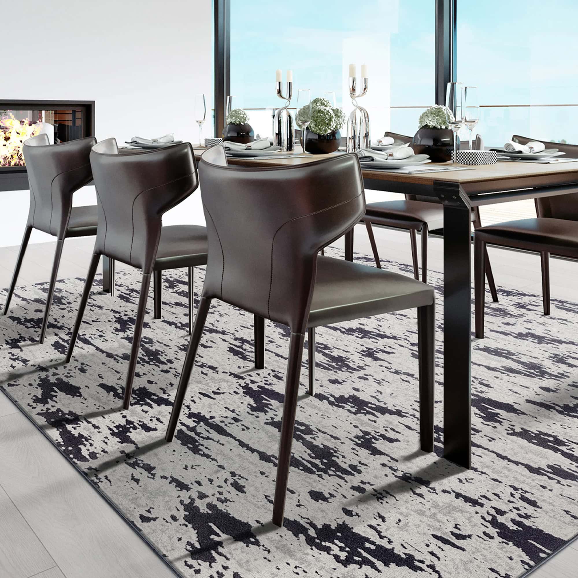 Modern dining room with Arabella patterned area rug and sleek black chairs.