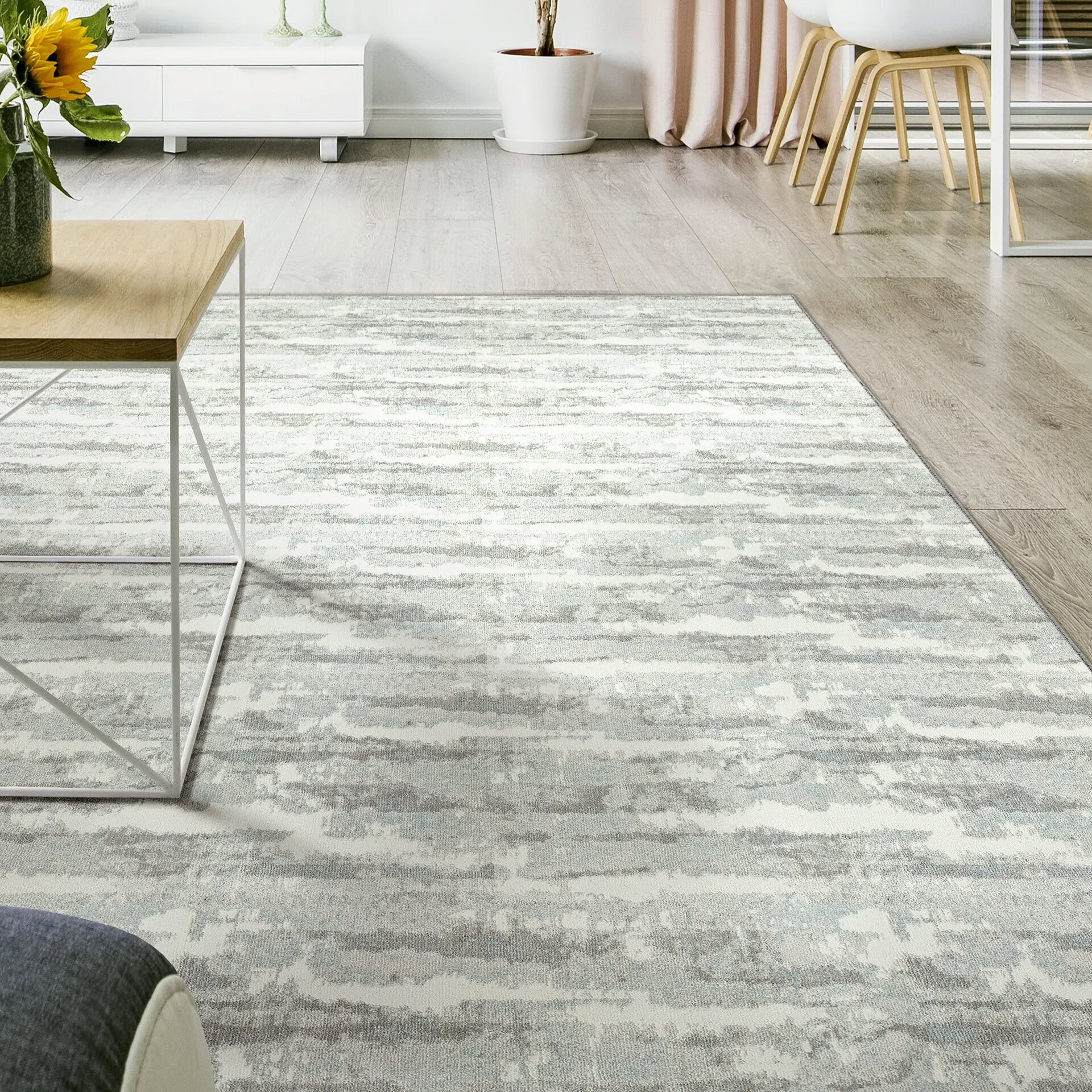Woven carpet in a modern living room with light gray tones and subtle pattern.