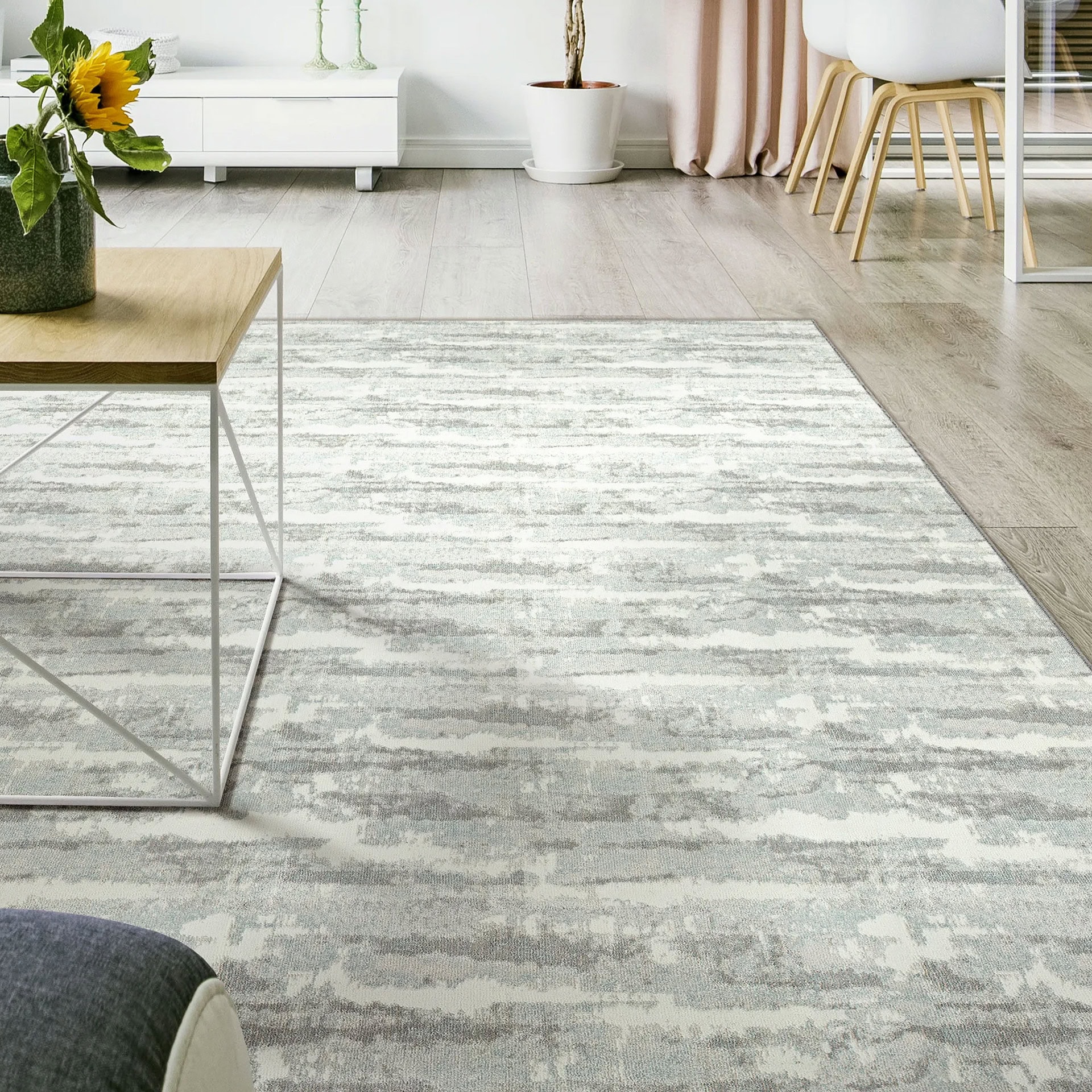 Woven carpet in a modern living room with light gray tones and subtle pattern.