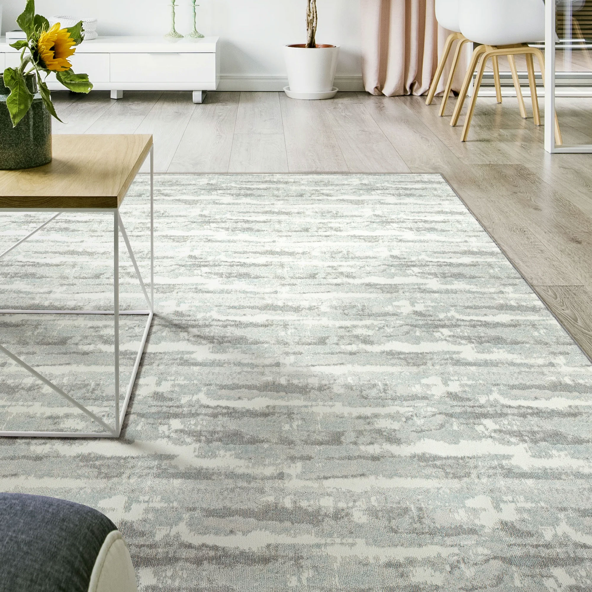 Woven carpet in a modern living room with light gray tones and subtle pattern.