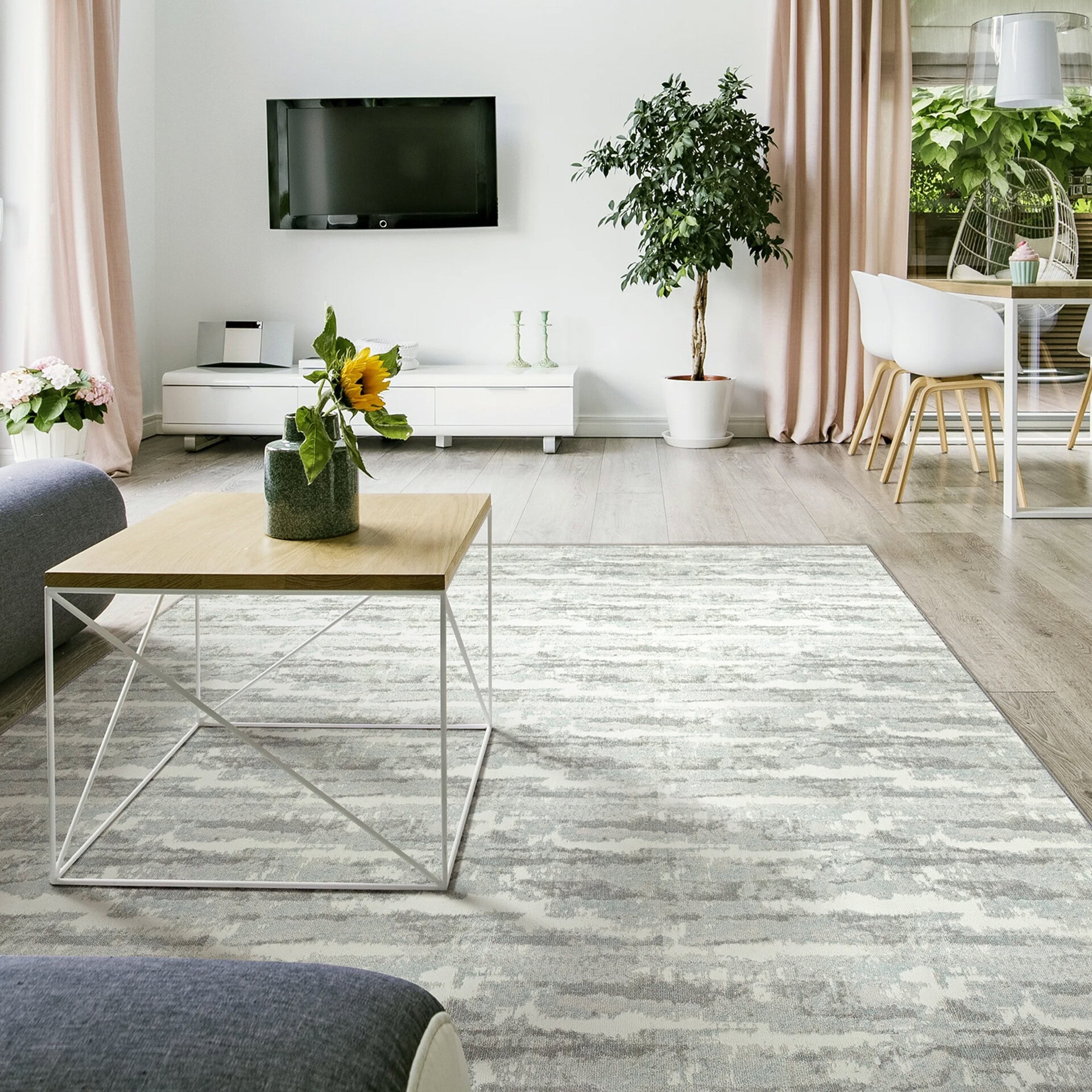 Woven carpet in a modern living room with light gray tones and subtle pattern.