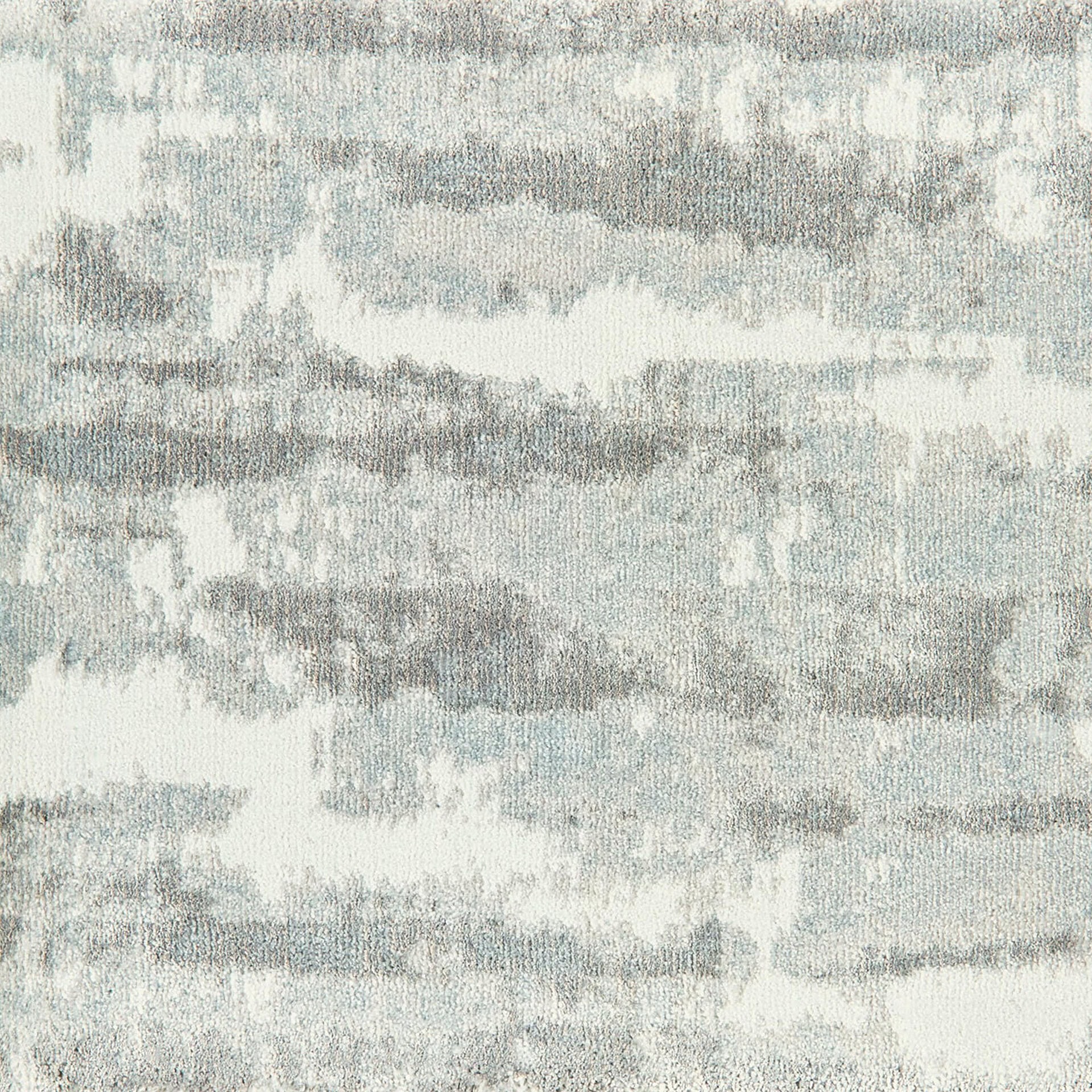 Woven carpet with abstract gray and white pattern, perfect for modern interiors.