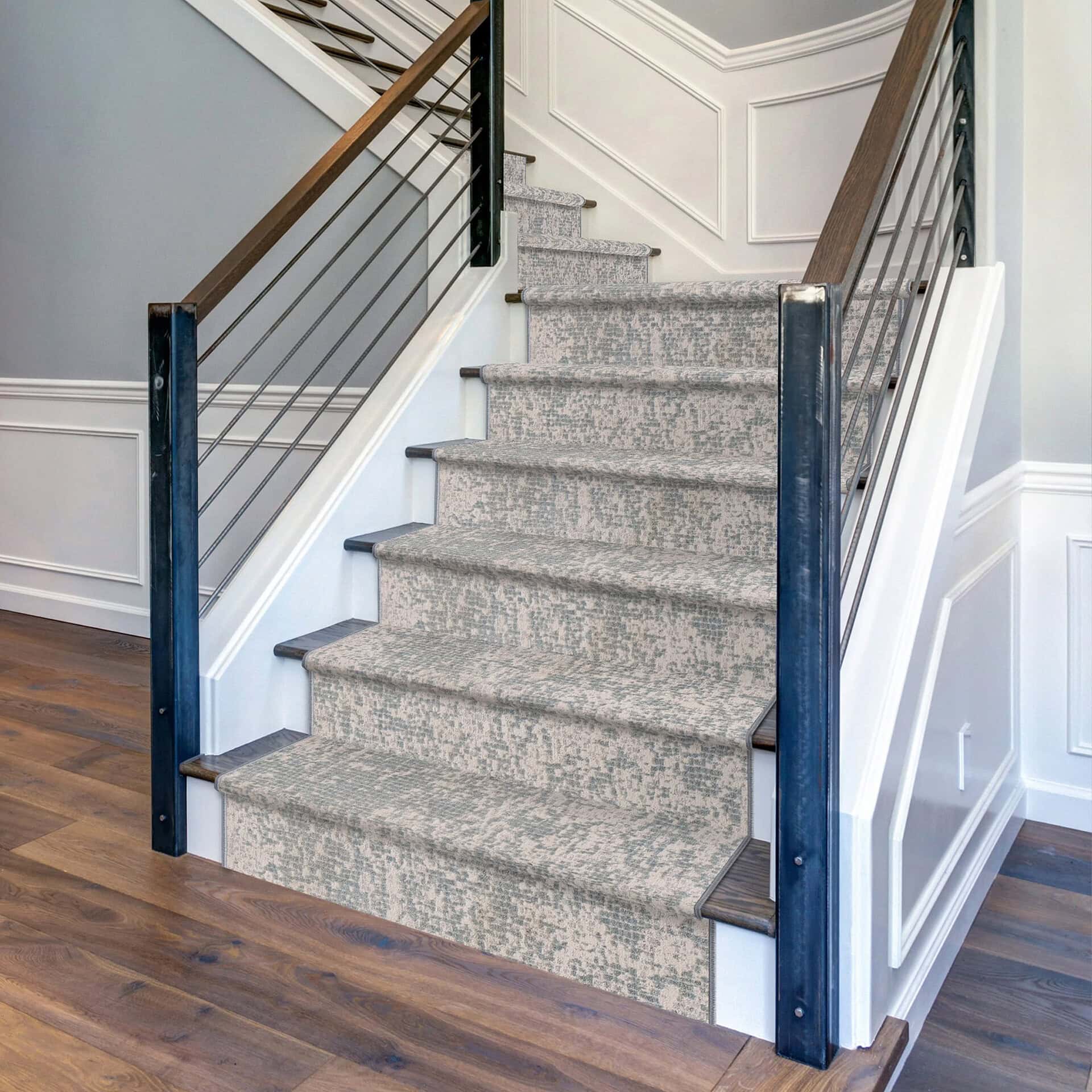 Elegant woven area rug on staircase with neutral tones.