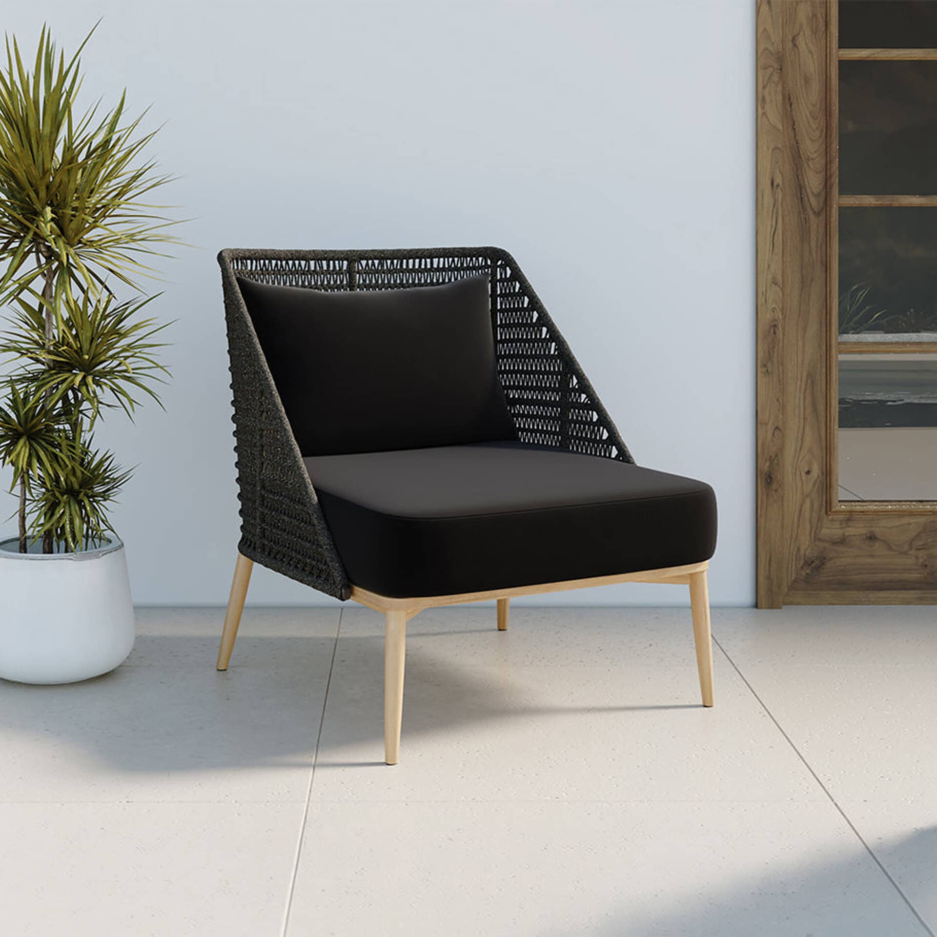 Elegant outdoor lounge chair with woven backrest and black cushion.