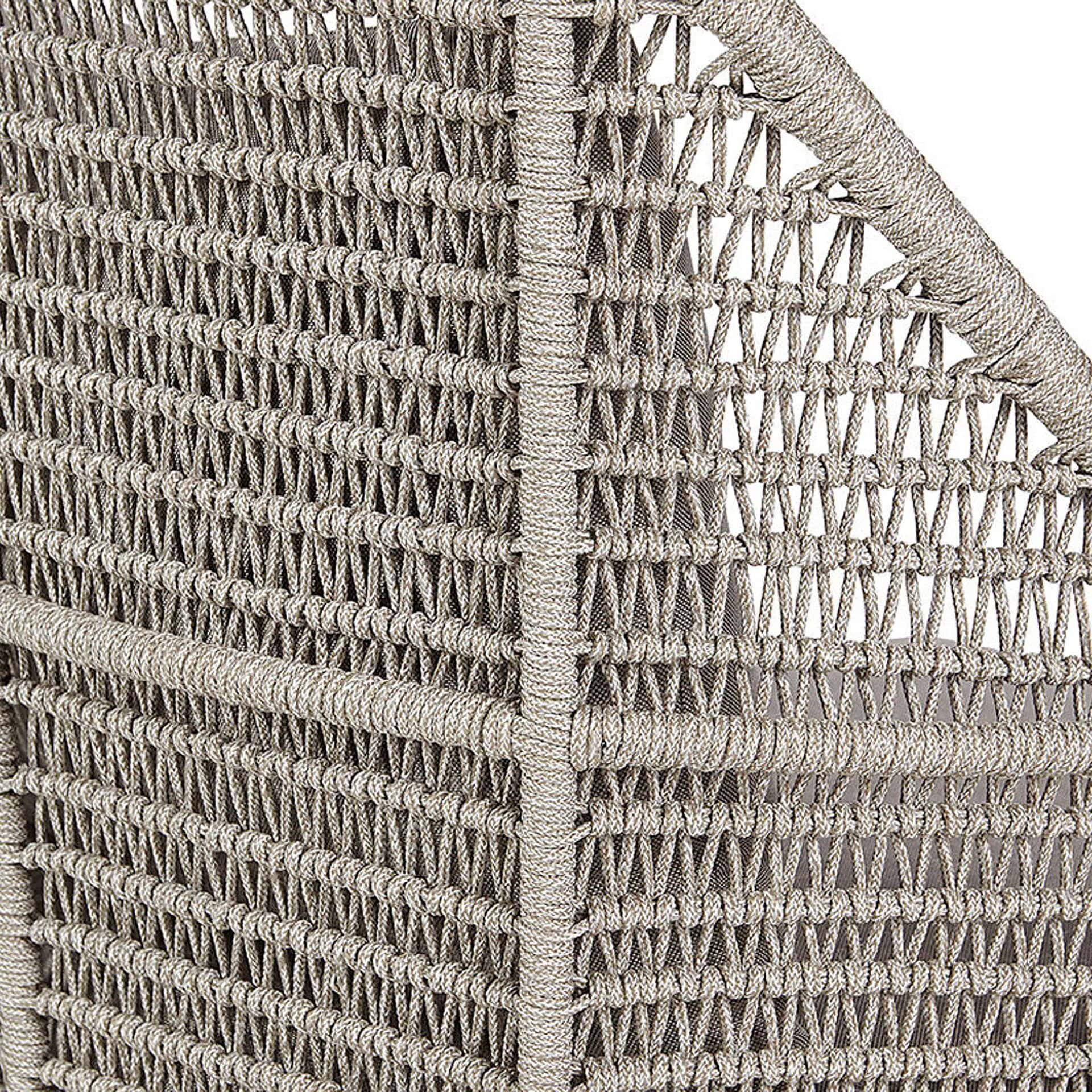 Outdoor lounge chair with woven rattan design.