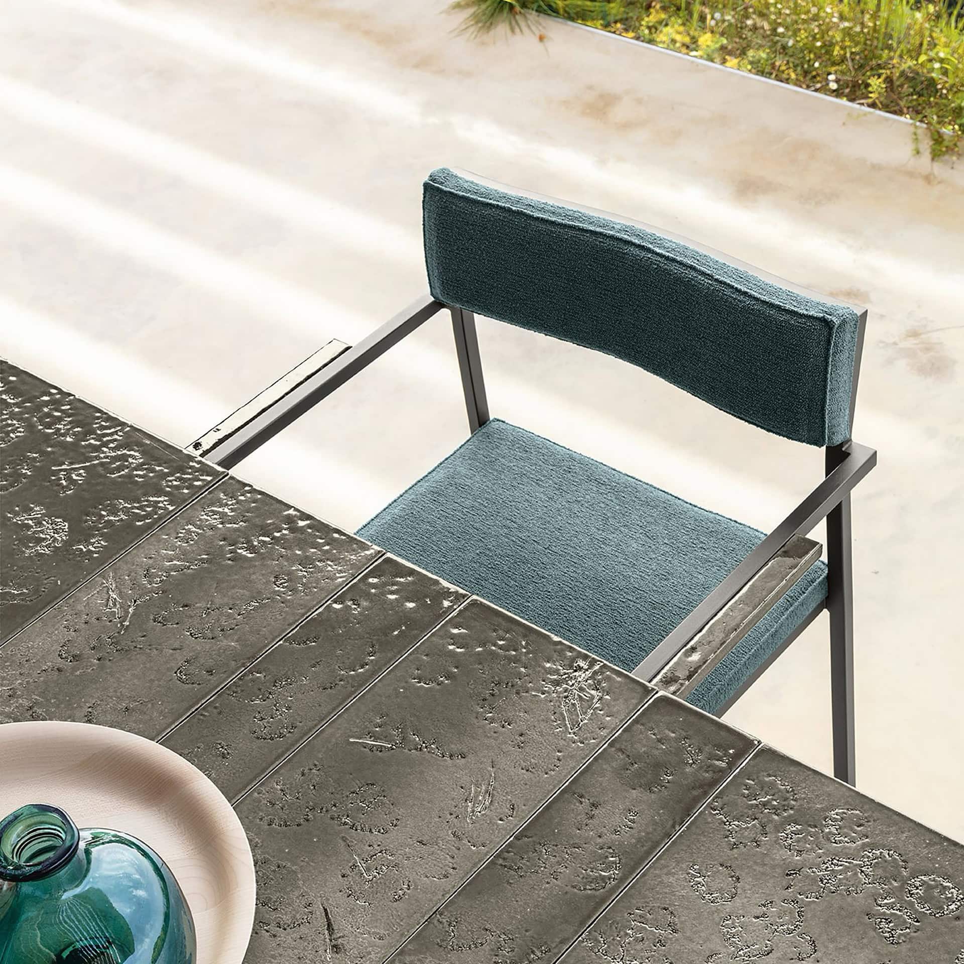 Outdoor dining chair with modern design and plush upholstery.