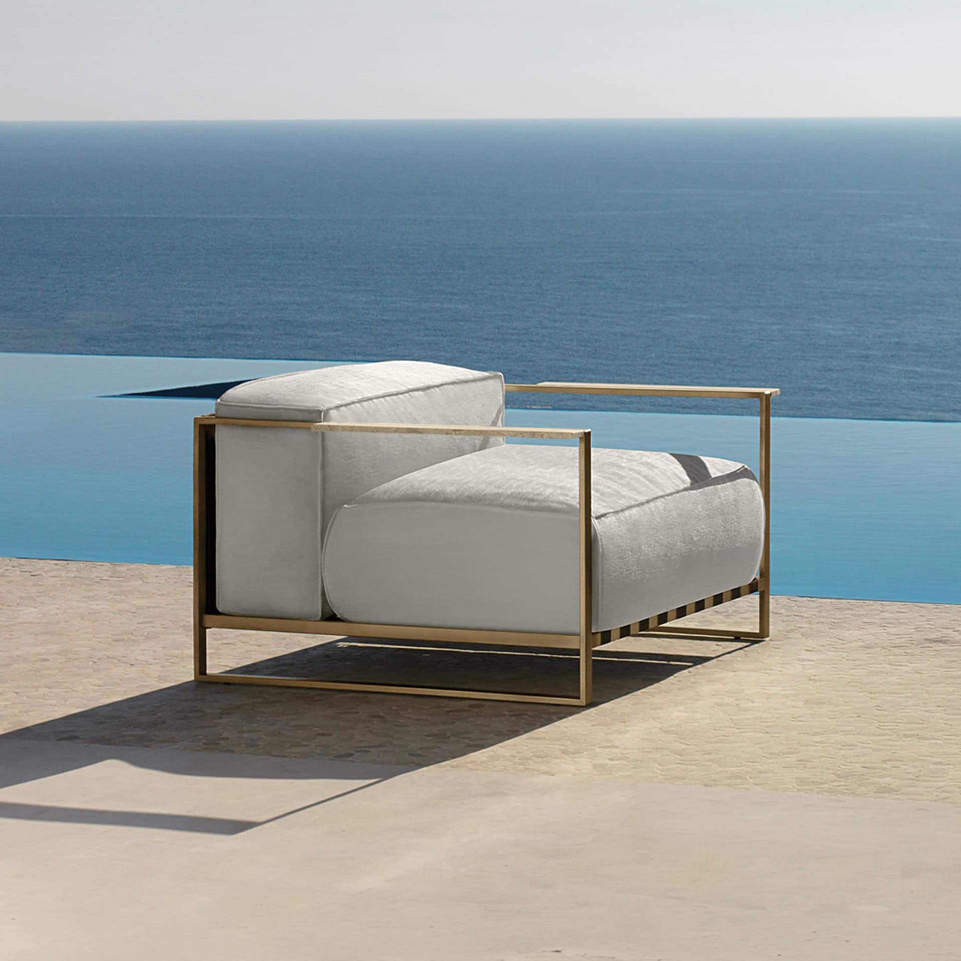 Outdoor lounge chair with a modern design and neutral cushions. Perfect for relaxing by the pool or.