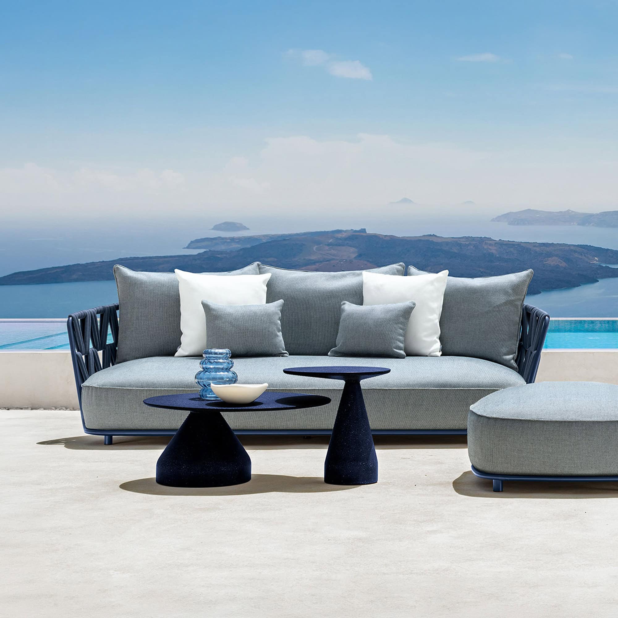 Elegant outdoor 2-seater sofa with plush cushions, perfect for relaxing by the poolside.