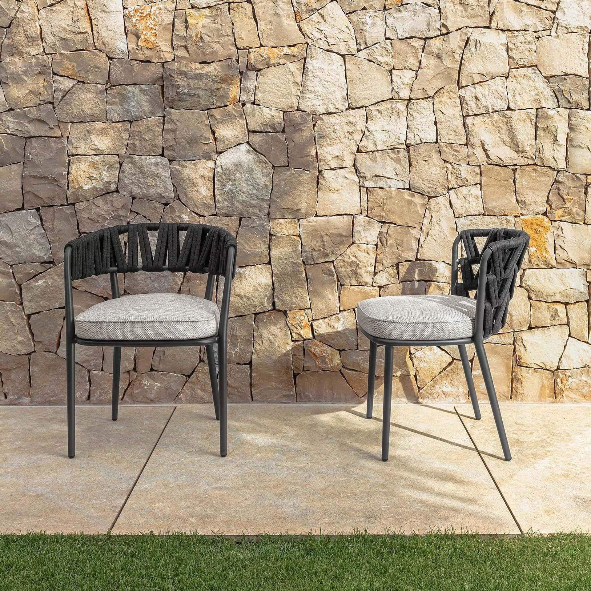 Outdoor dining chair with black frame and light gray cushion, perfect for patio or garden seating.