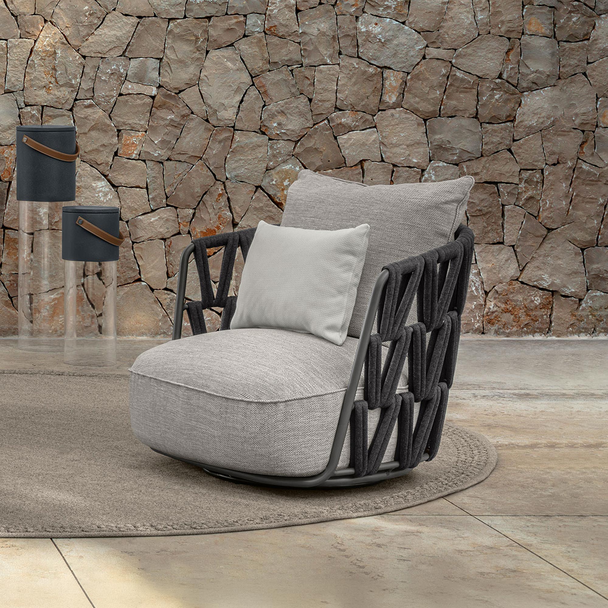 Outdoor lounge armchair with woven frame and plush cushions.