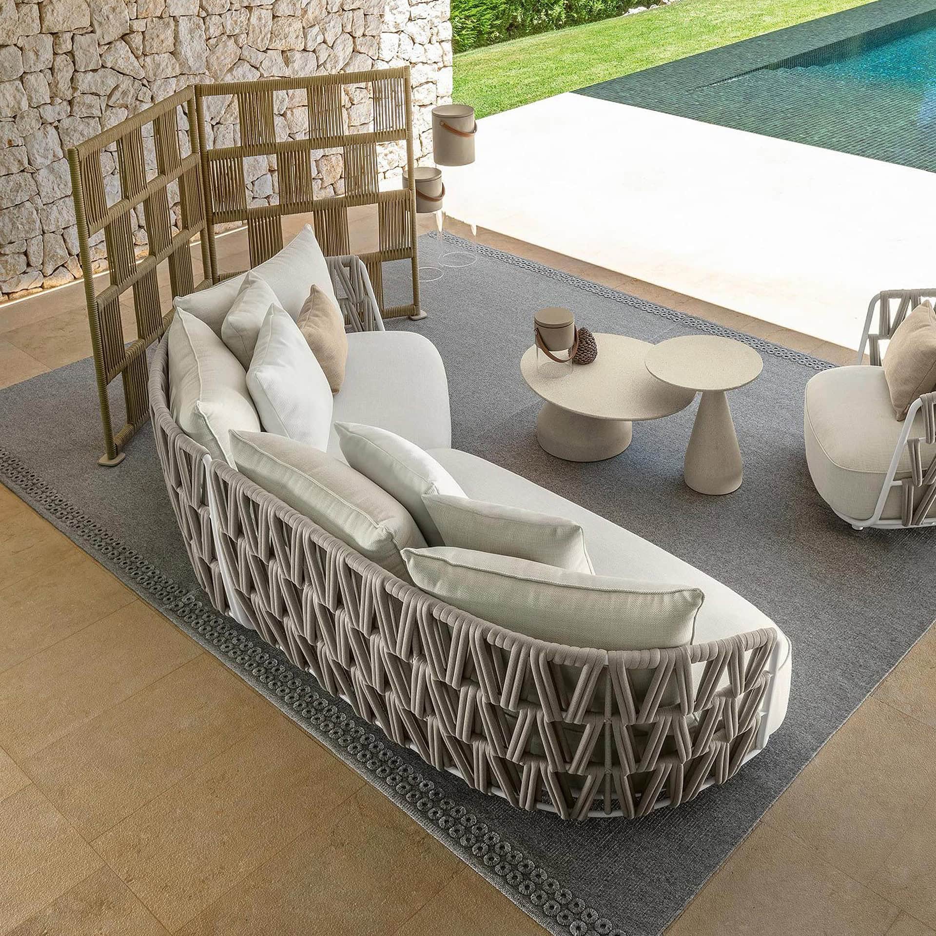 Outdoor modular sectional sofa for poolside relaxation.