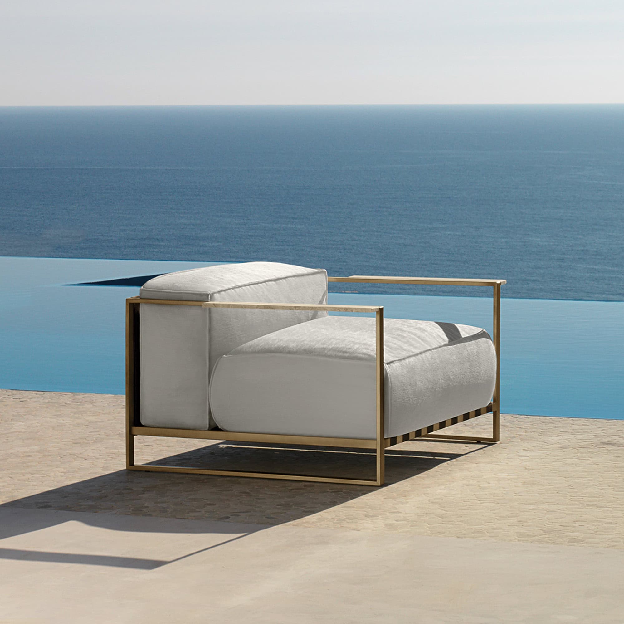 Outdoor lounge chair with a modern design and neutral cushions. Perfect for relaxing by the pool or.