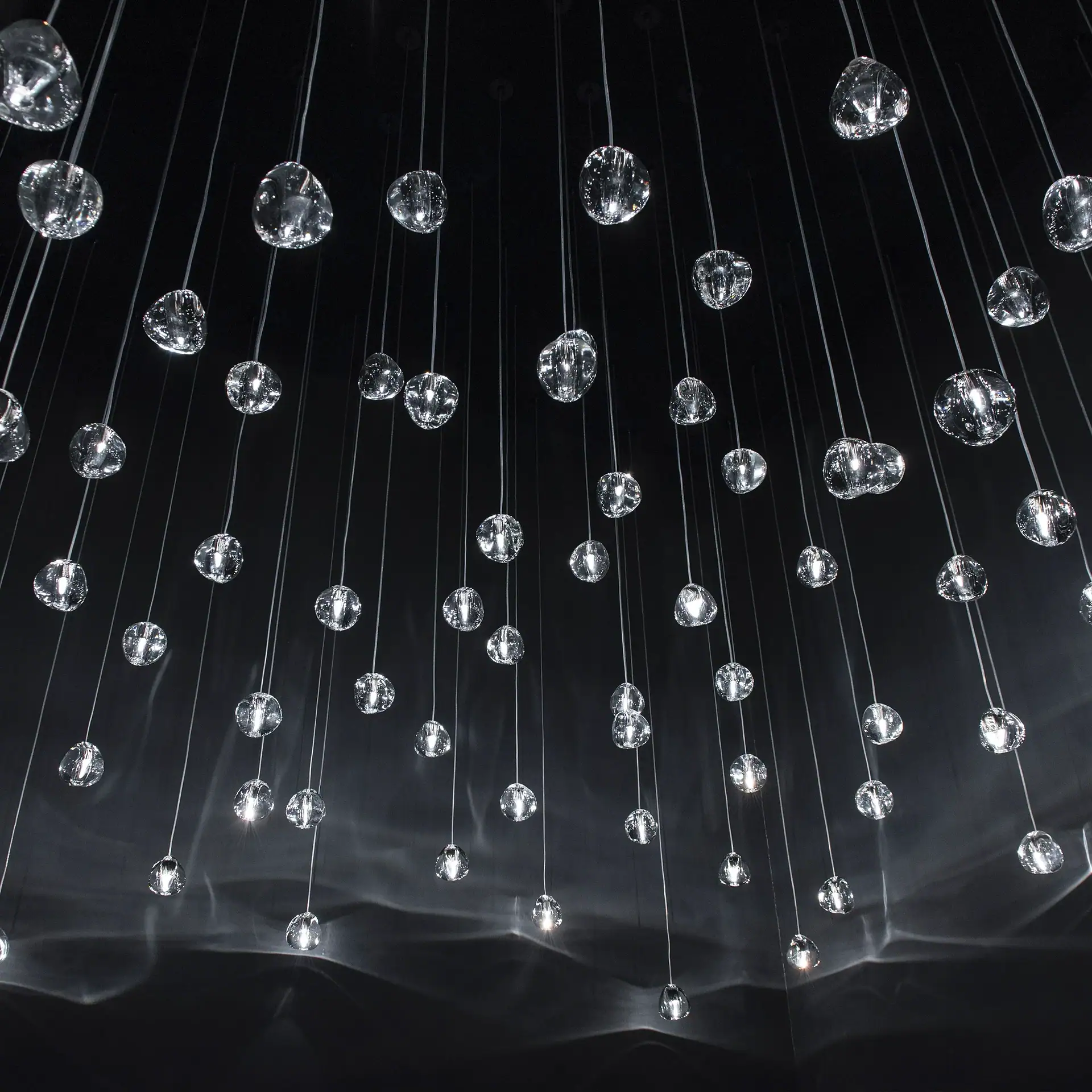 Modern crystal chandelier with hanging glass orbs, ideal for upscale interior decor.