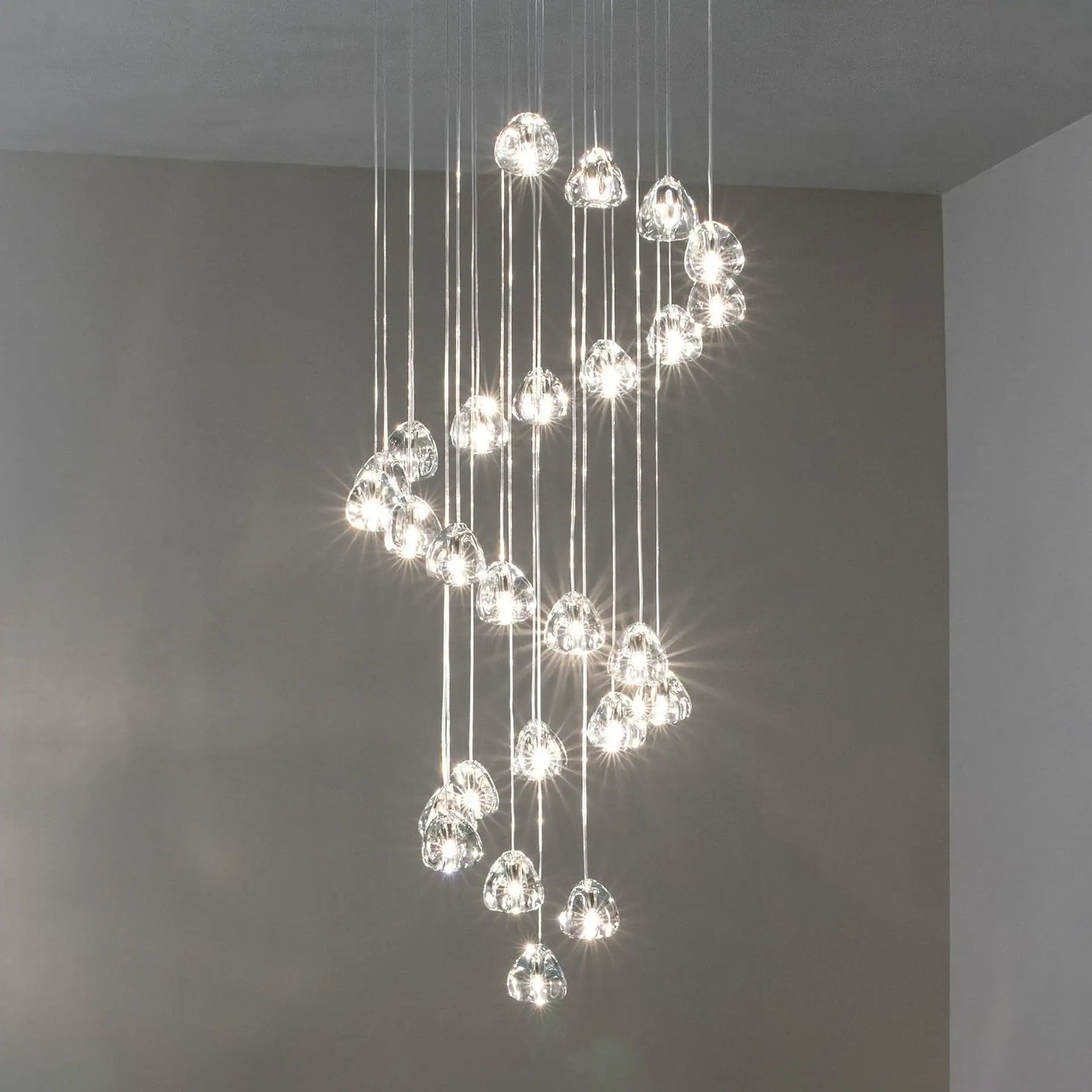 Elegant glass pendant chandelier with multiple hanging lights for modern interior design.