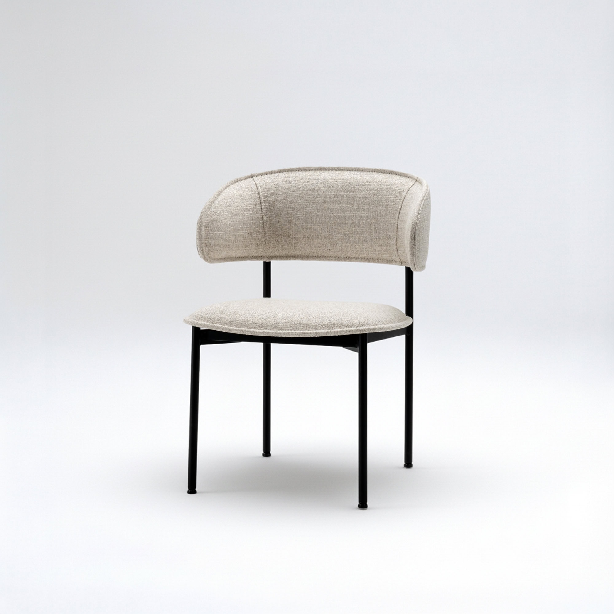 Upholstered side dining chair with elegant beige fabric and black metal legs, perfect for modern din.