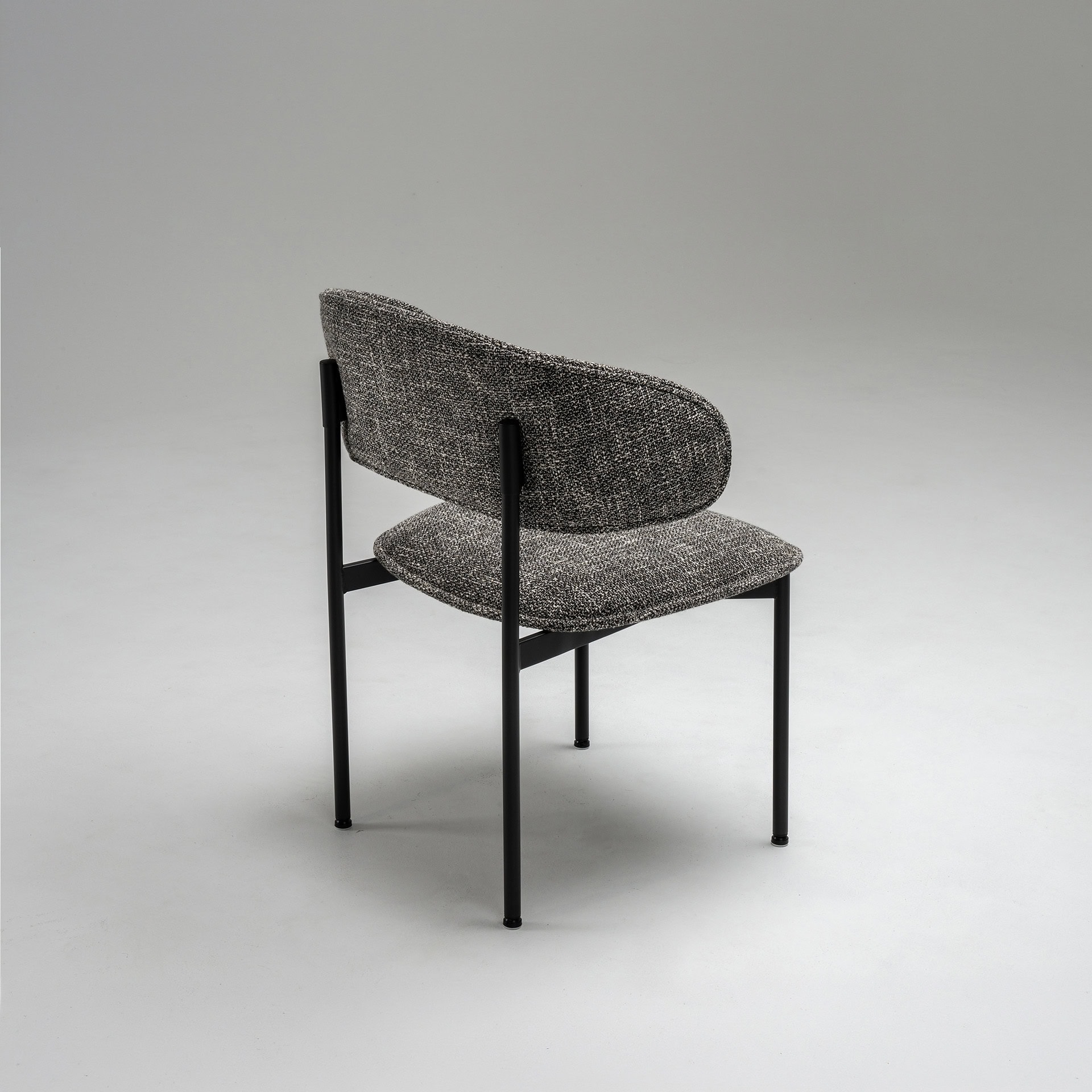 Upholstered side dining chair with modern design, grey fabric, and black metal frame. Perfect for co.