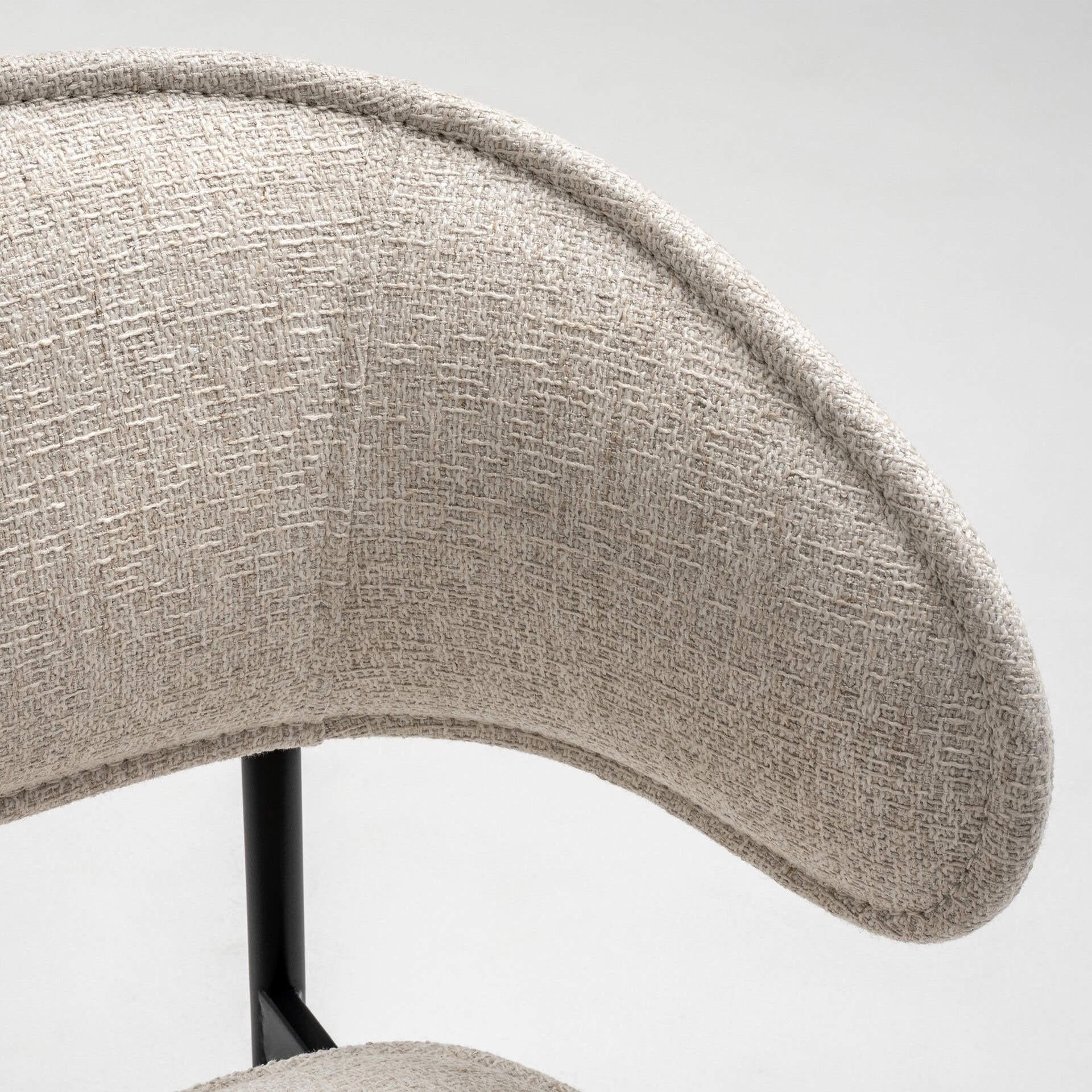 Upholstered Chloé dining chair with curved backrest and neutral fabric. Perfect for modern dining ro.