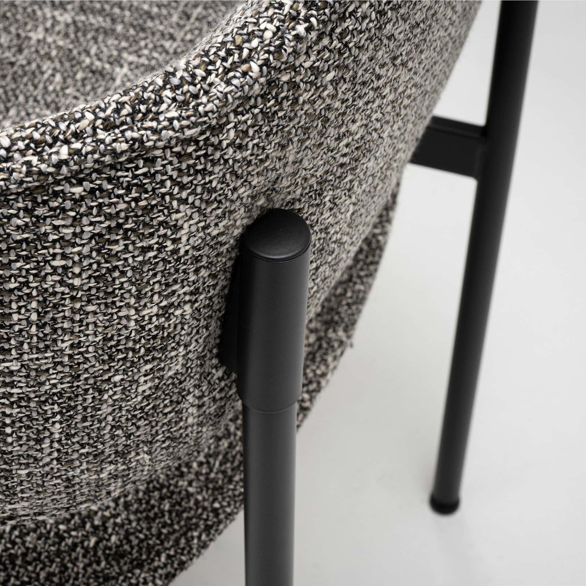 Upholstered side dining chair with textured fabric and black metal legs. Perfect for modern dining s.