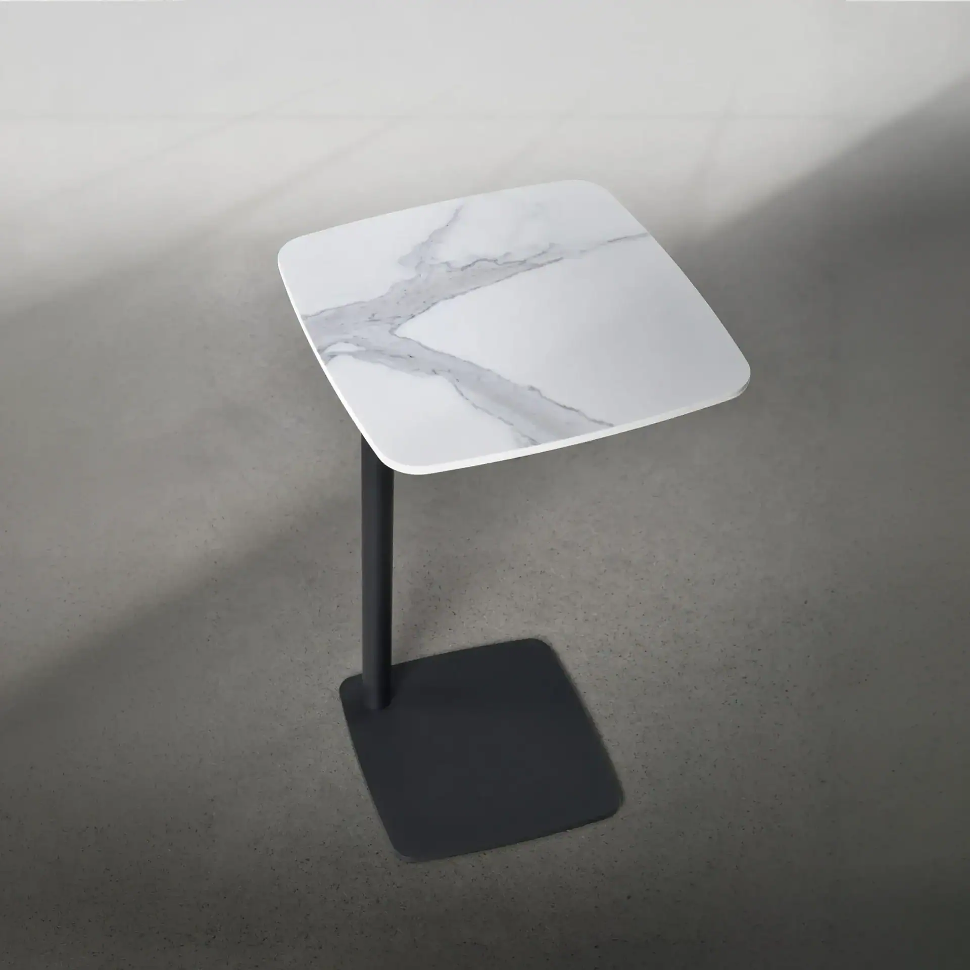 Elegant side table with marble top and black metal base for contemporary interiors.