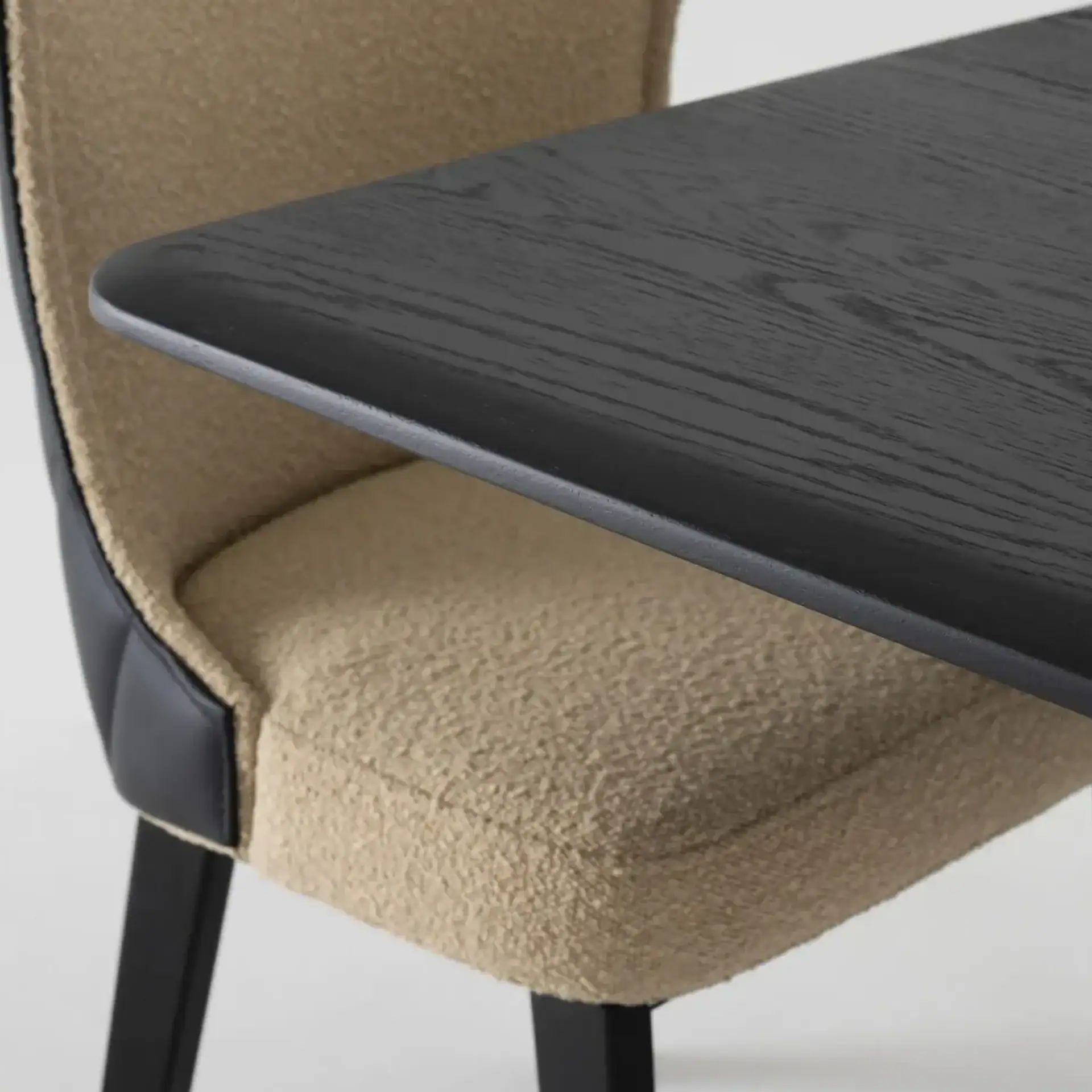 Beige upholstered chair with black wooden legs, ideal for contemporary dining or office spaces.