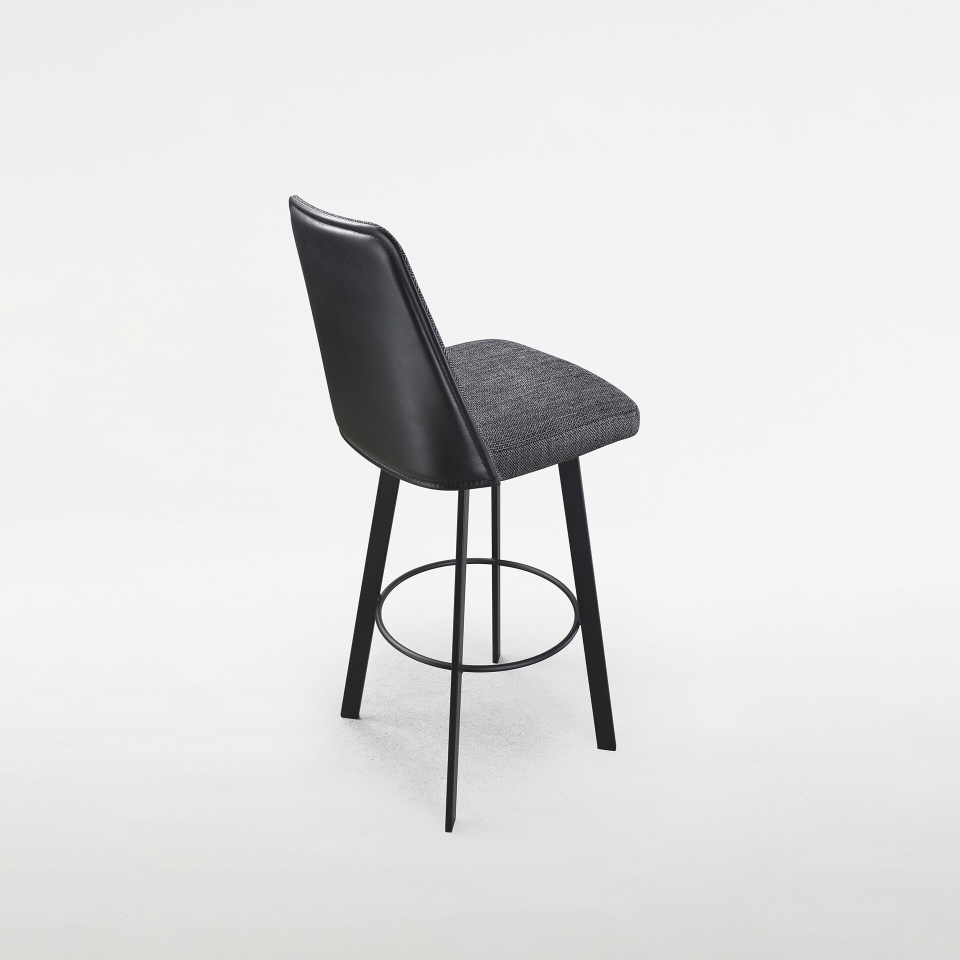 Modern Sofia swivel bar and counter stool with black leather and fabric seat.