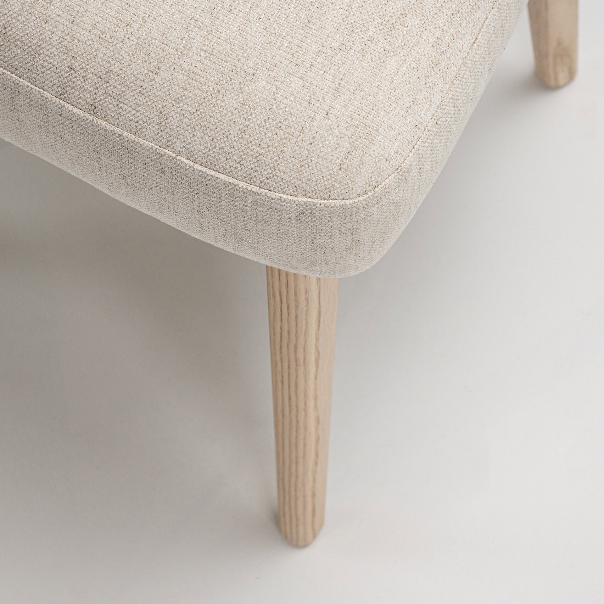 Upholstered Tessa dining armchair with wooden leg, modern and elegant design. Perfect for contempora.