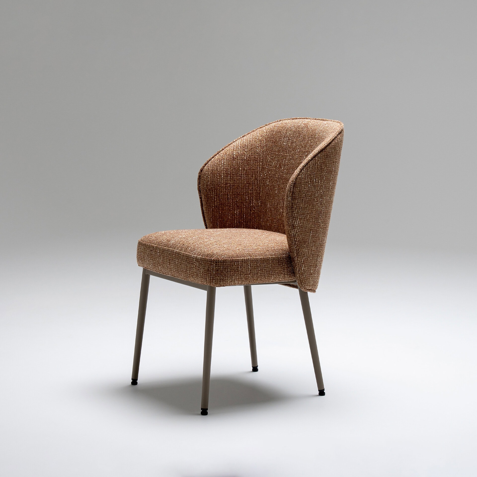 Elegant Tessa upholstered dining armchair with curved backrest and fabric upholstery. Perfect for mo.