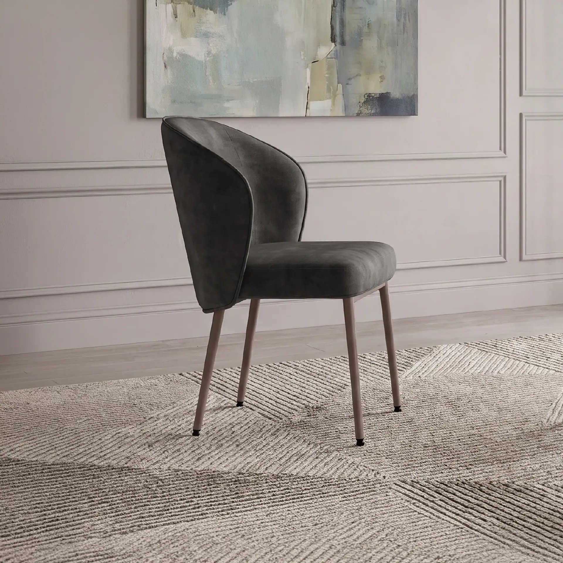 Tessa upholstered dining armchair in dark fabric in a modern room.