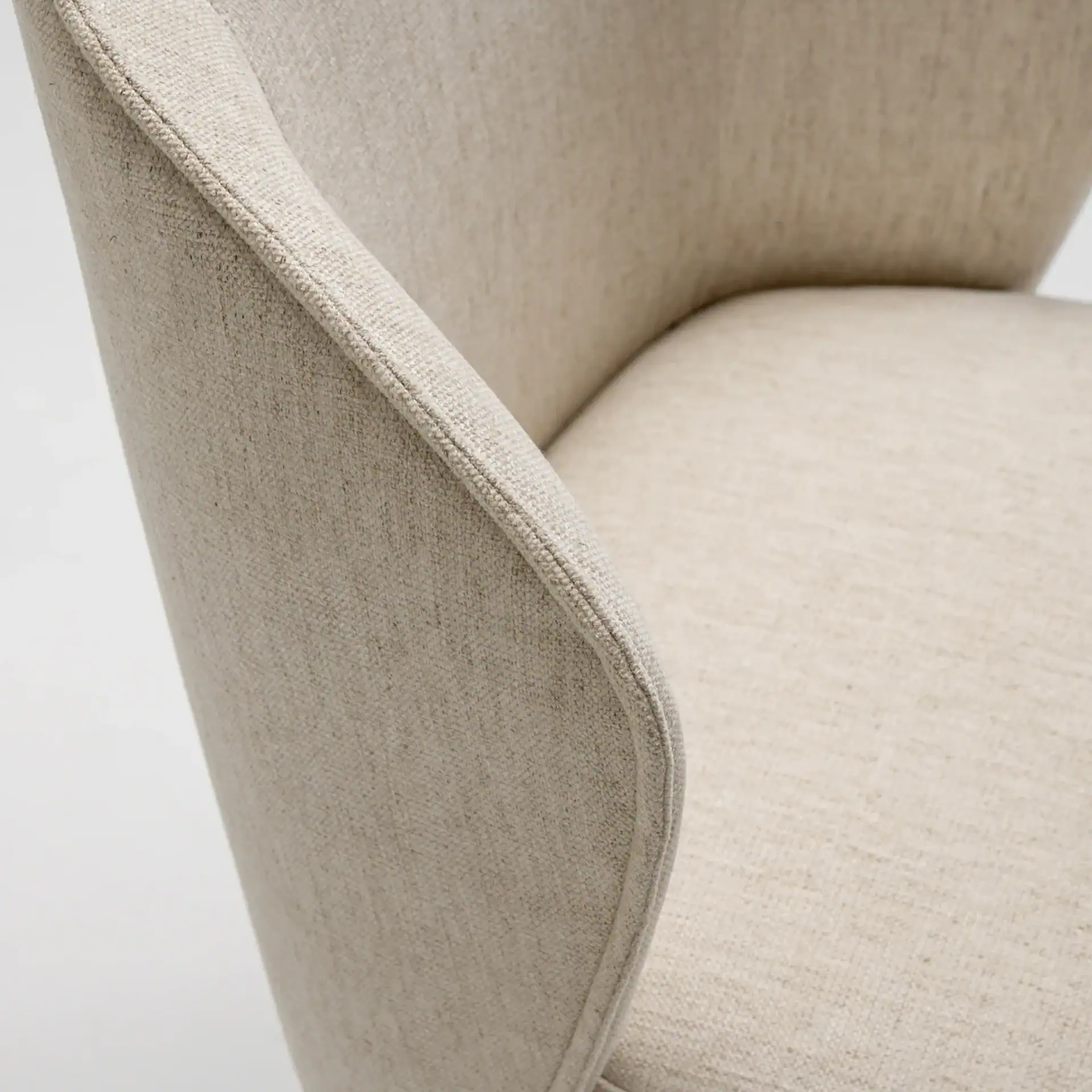 Tessa Upholstered Dining Armchair in beige fabric with curved backrest.
