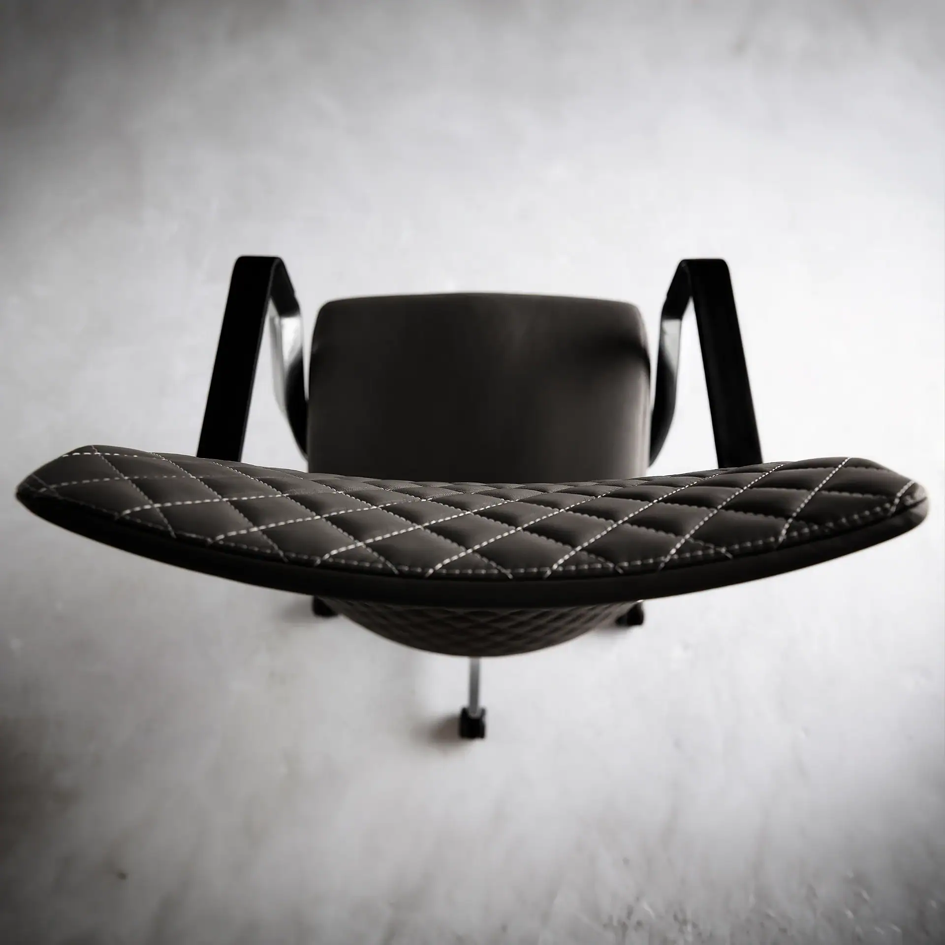 Proform Office Chair with quilted black seat and armrests.