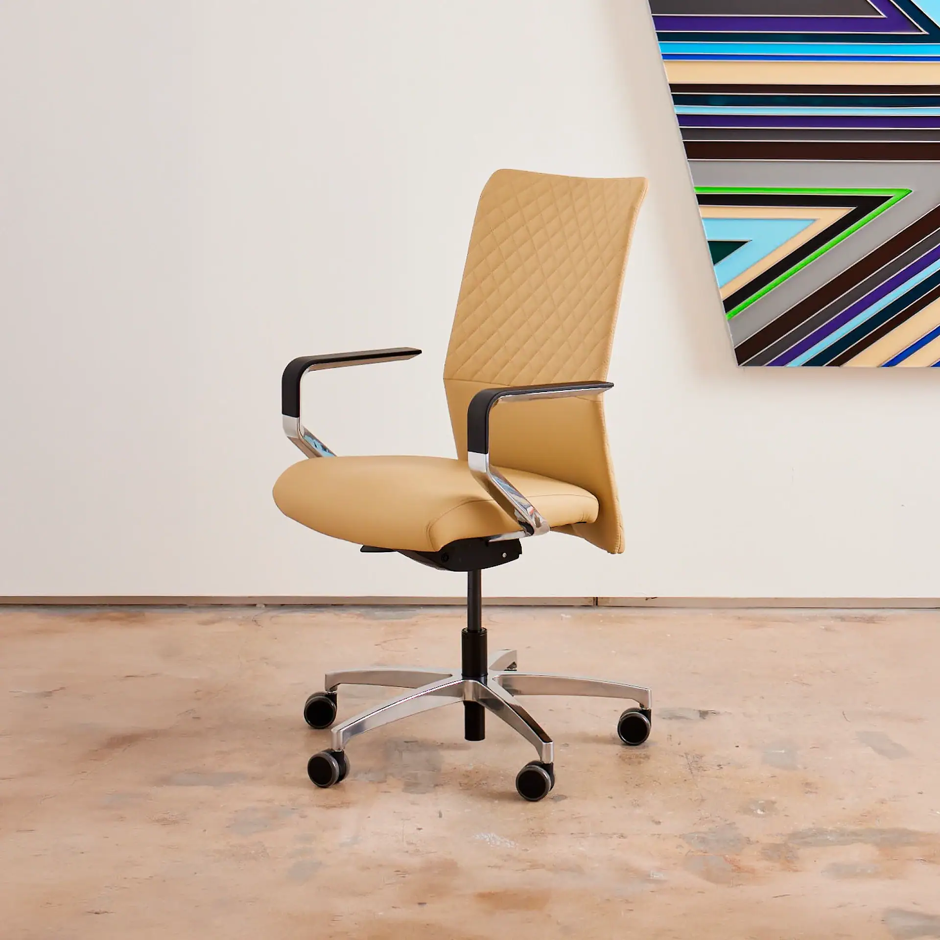 Proform office chair with beige upholstery and black armrests in a modern room.