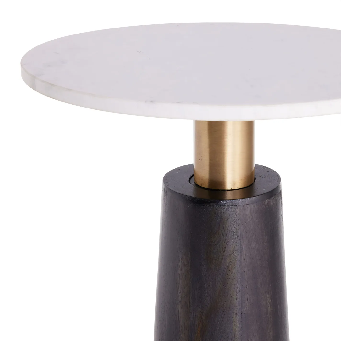 A modern side table with a white marble top, brass stem, and dark tapered wood base, set against a white background.
