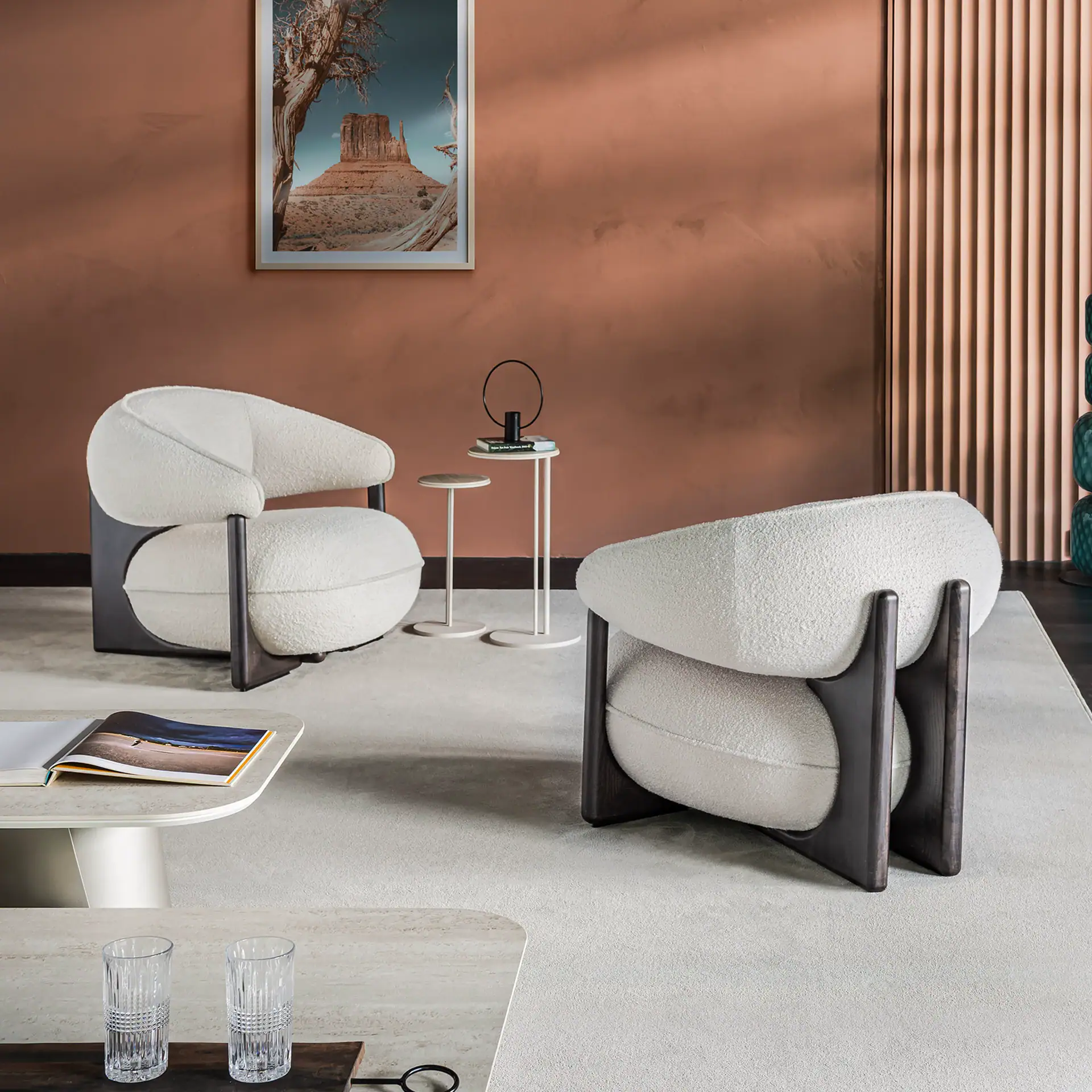 Contemporary Ruby Lounge Armchair with plush white upholstery and black wooden legs.