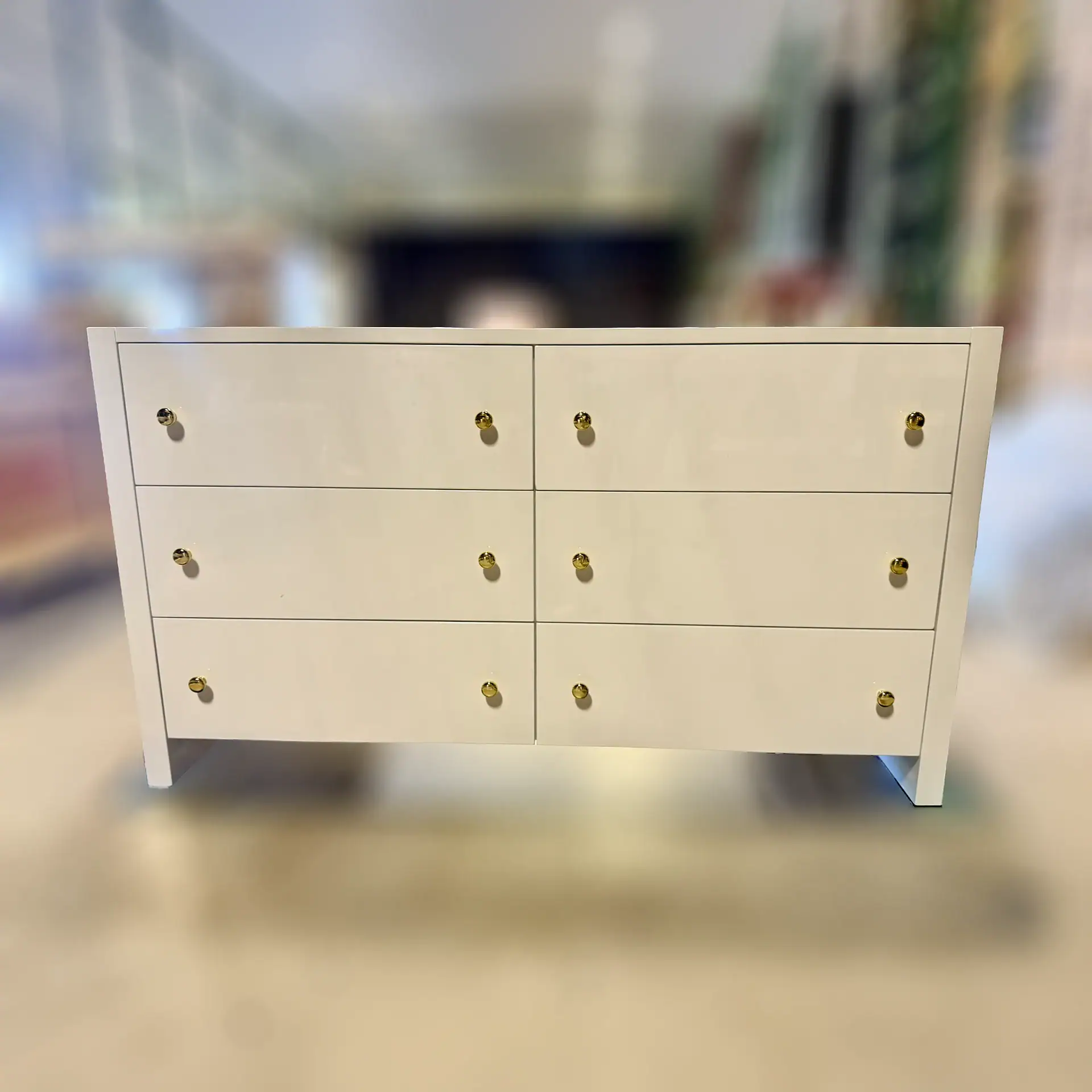 White Bernhardt 6-drawer dresser with gold knobs for modern bedroom decor.
