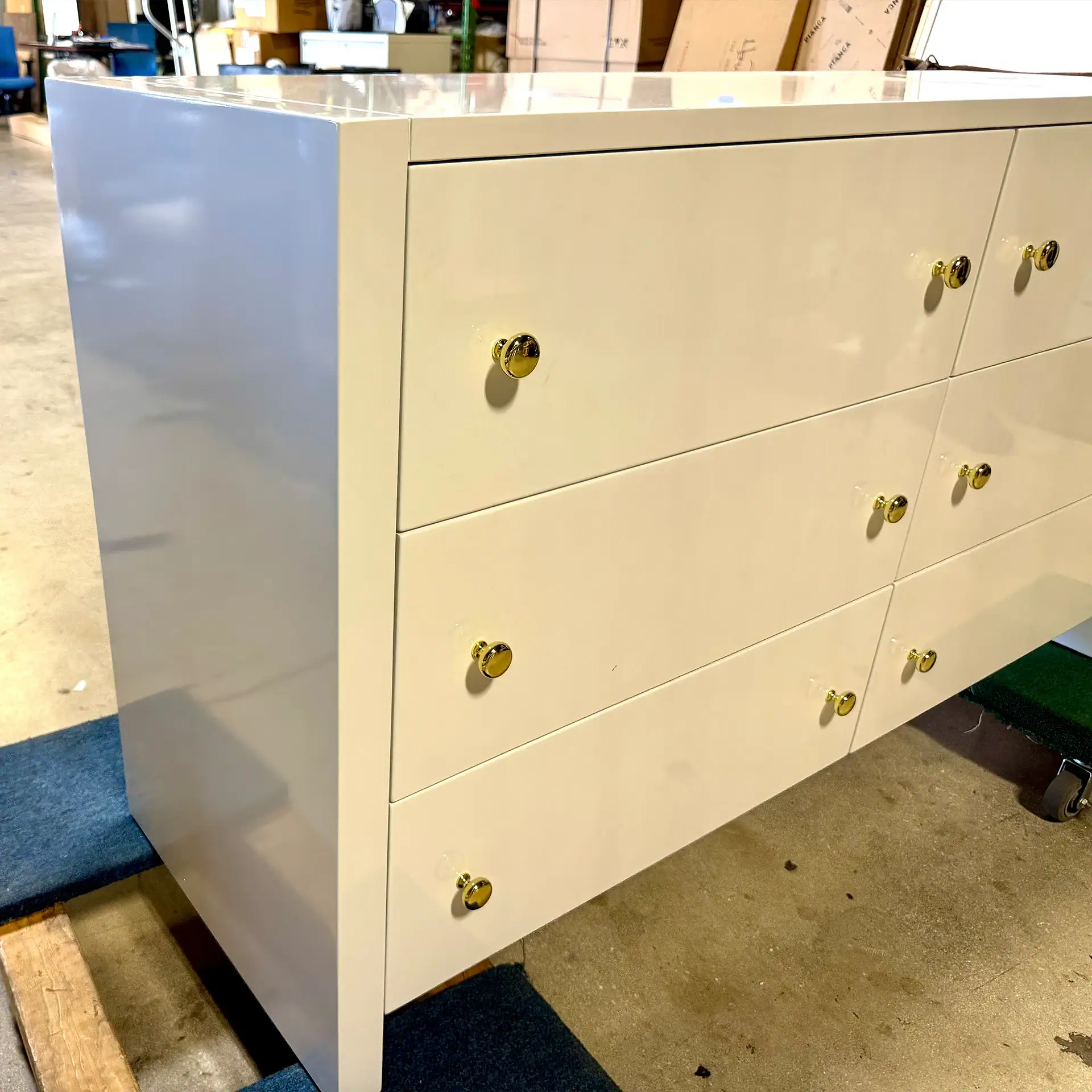 White 6-drawer dresser with gold knobs from Sklar Furnishings.