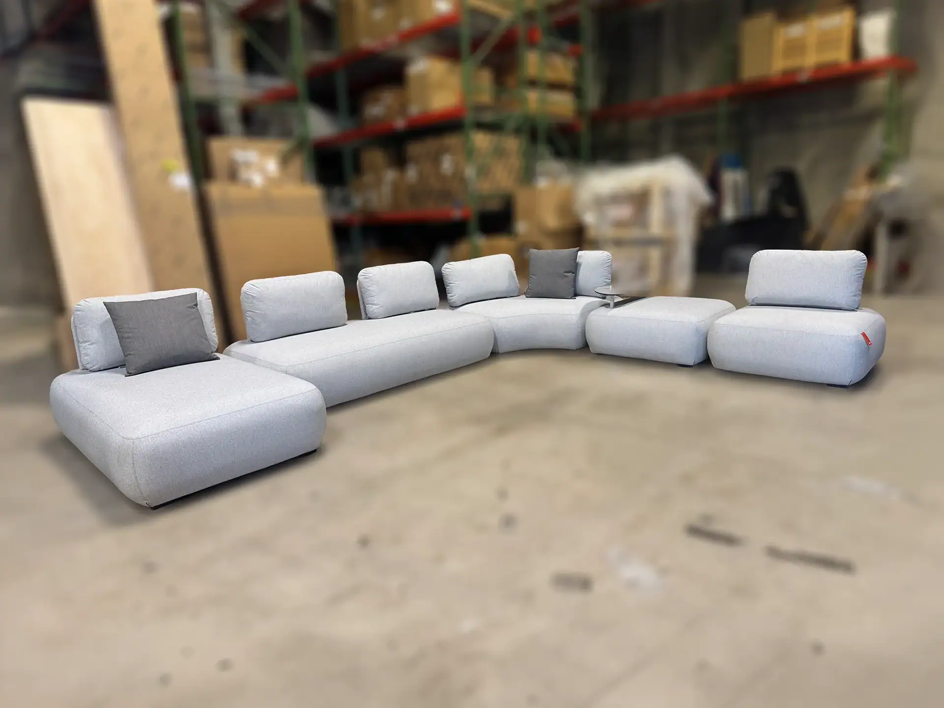 Modern outdoor sectional sofa with light gray cushions and adjustable headrests.