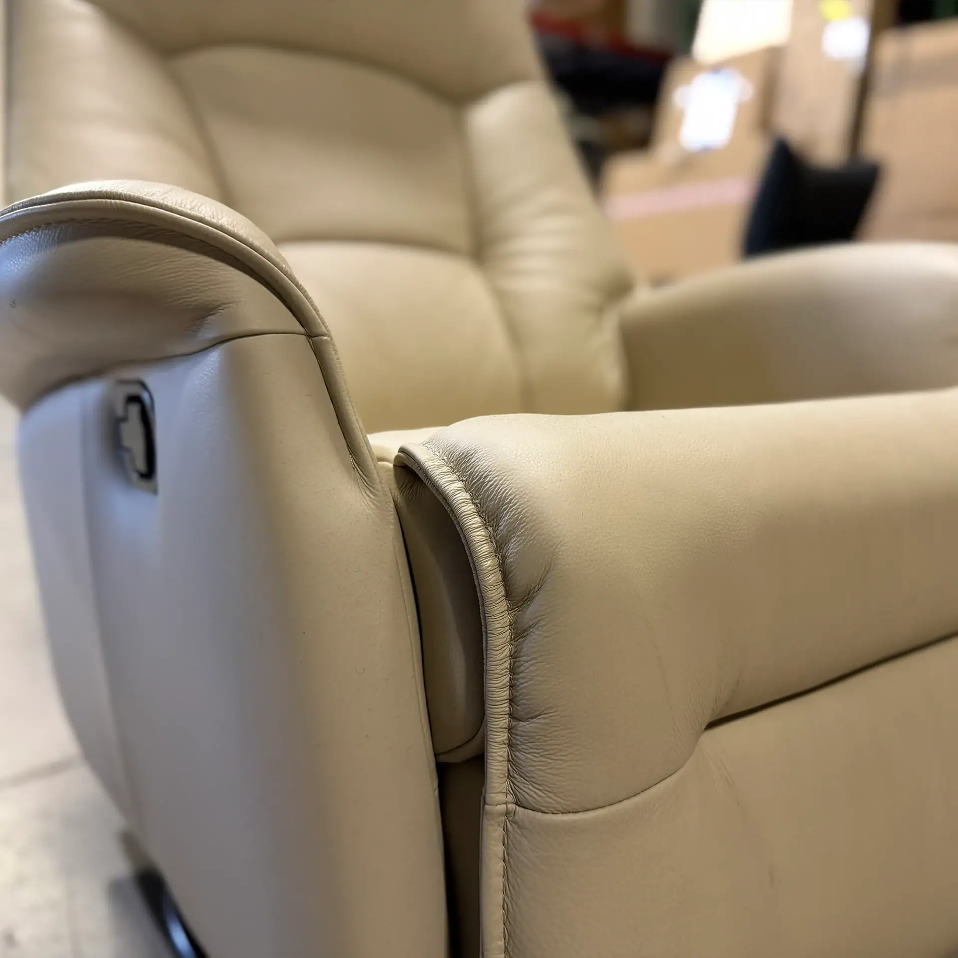Close-up of the Fjords Stockholm power recliner's armrest and control panel.