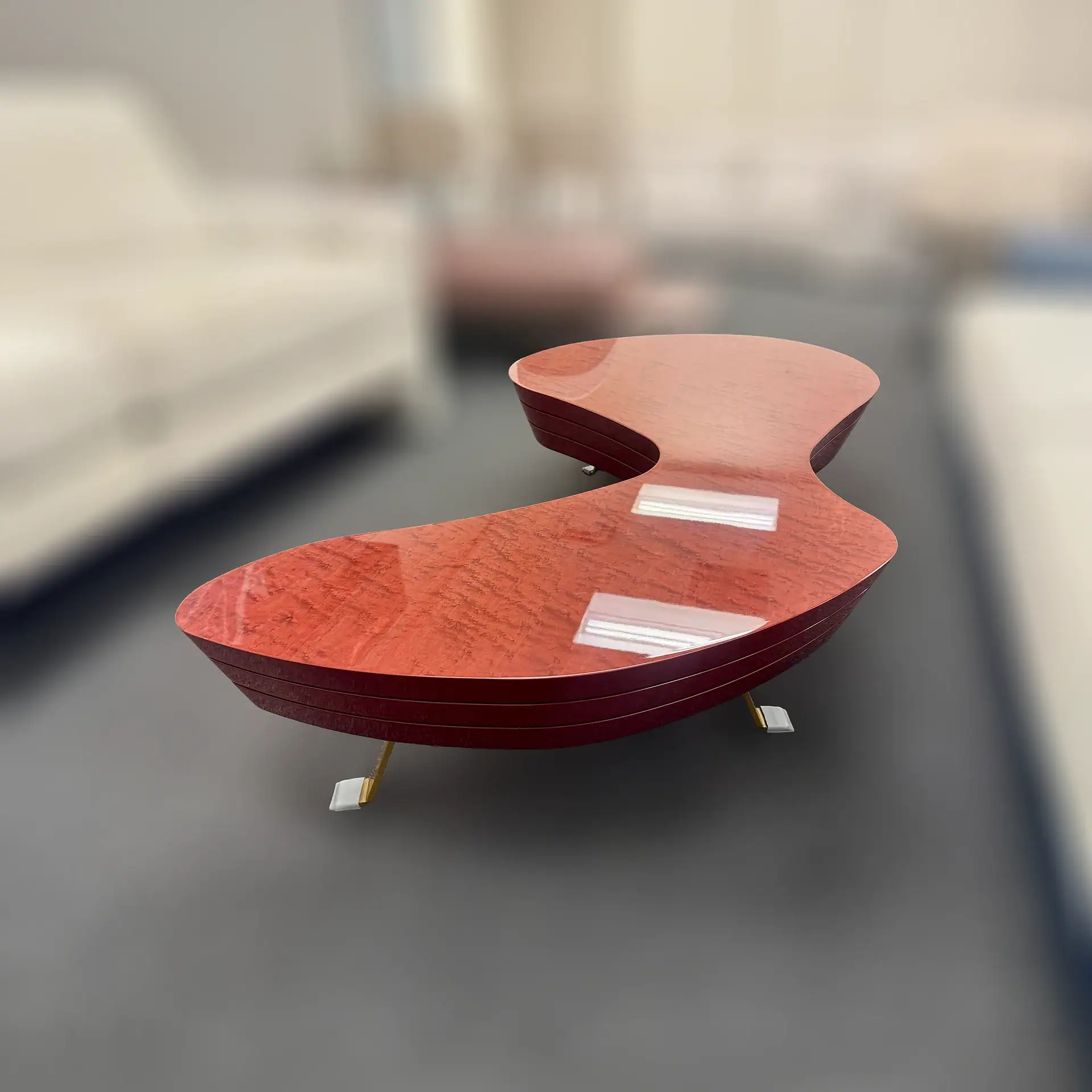 Modern wooden coffee table with unique curved design in showroom.